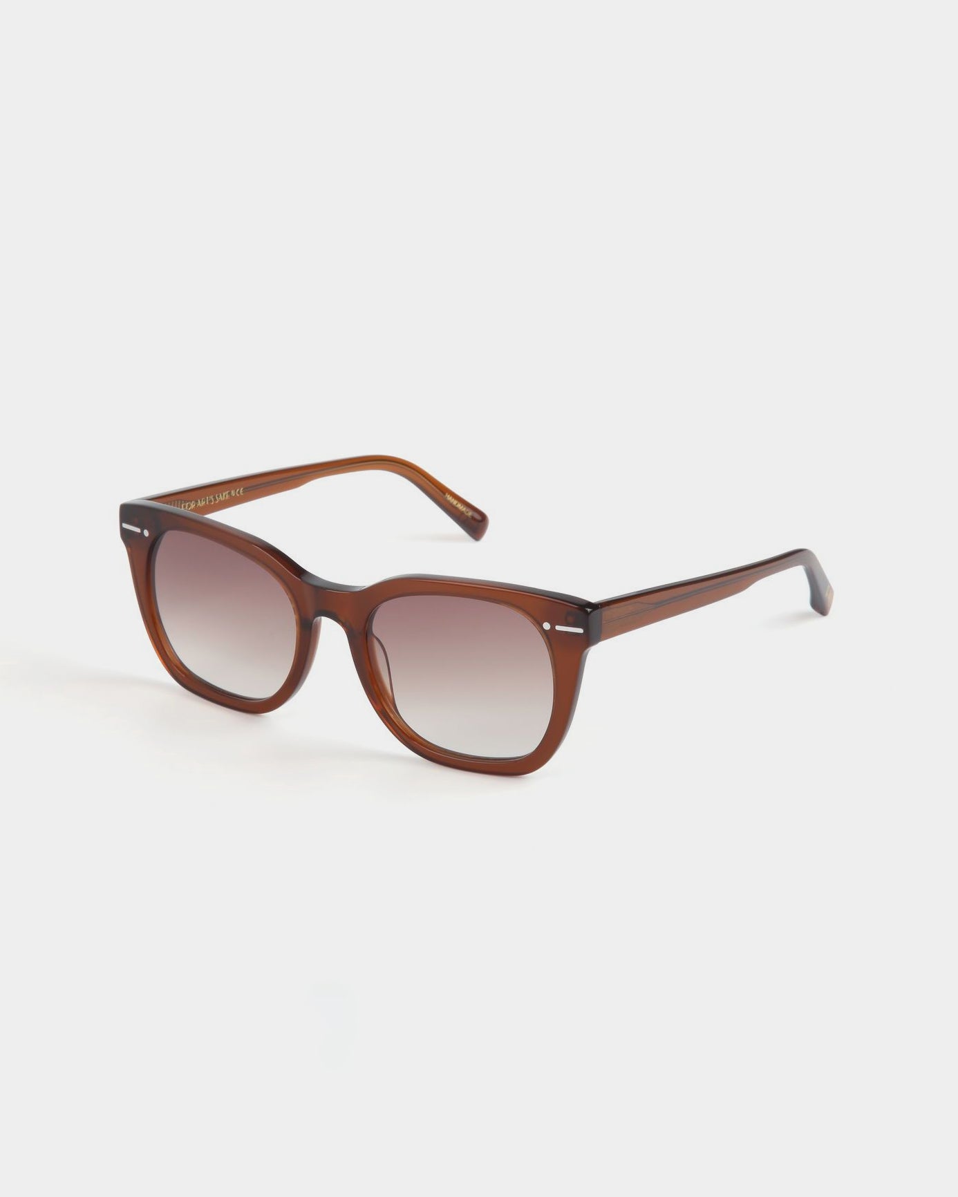 A pair of brown-framed Jacuzzi sunglasses with rectangular nylon lenses, transitioning from a solid brown tint at the top to a lighter shade at the bottom. The design is stylish and modern, featuring slightly curved arms and a glossy finish, while offering full UVA &amp; UVB protection. The brand behind this model is For Art&#39;s Sake®.