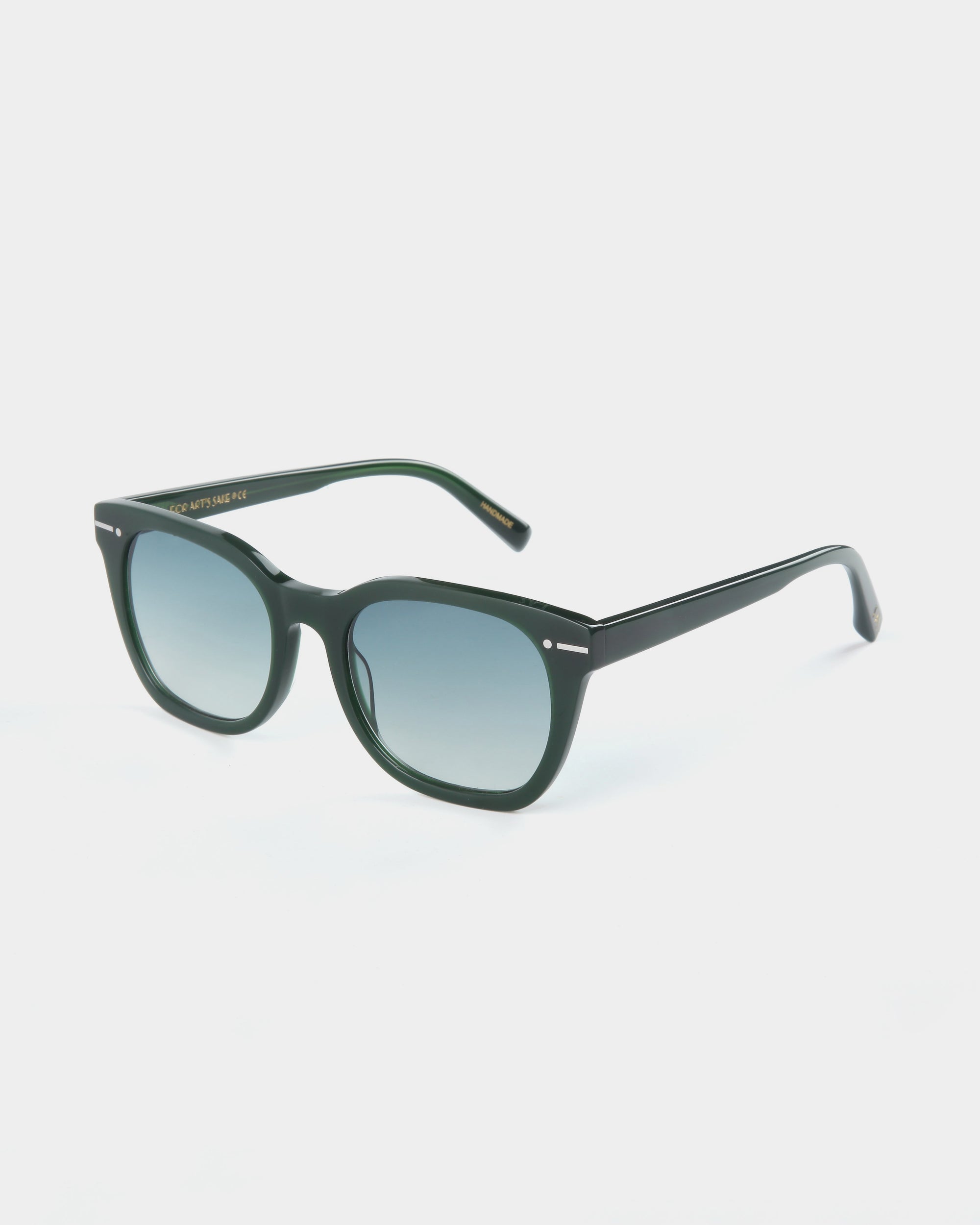 A pair of dark green, rectangular Jacuzzi sunglasses crafted from durable Mazzucchelli acetate with blue gradient nylon lenses offering full UVA &amp; UVB protection by For Art&#39;s Sake®. The frame has a glossy finish and small metal accents near the hinges. The background is a plain white surface.