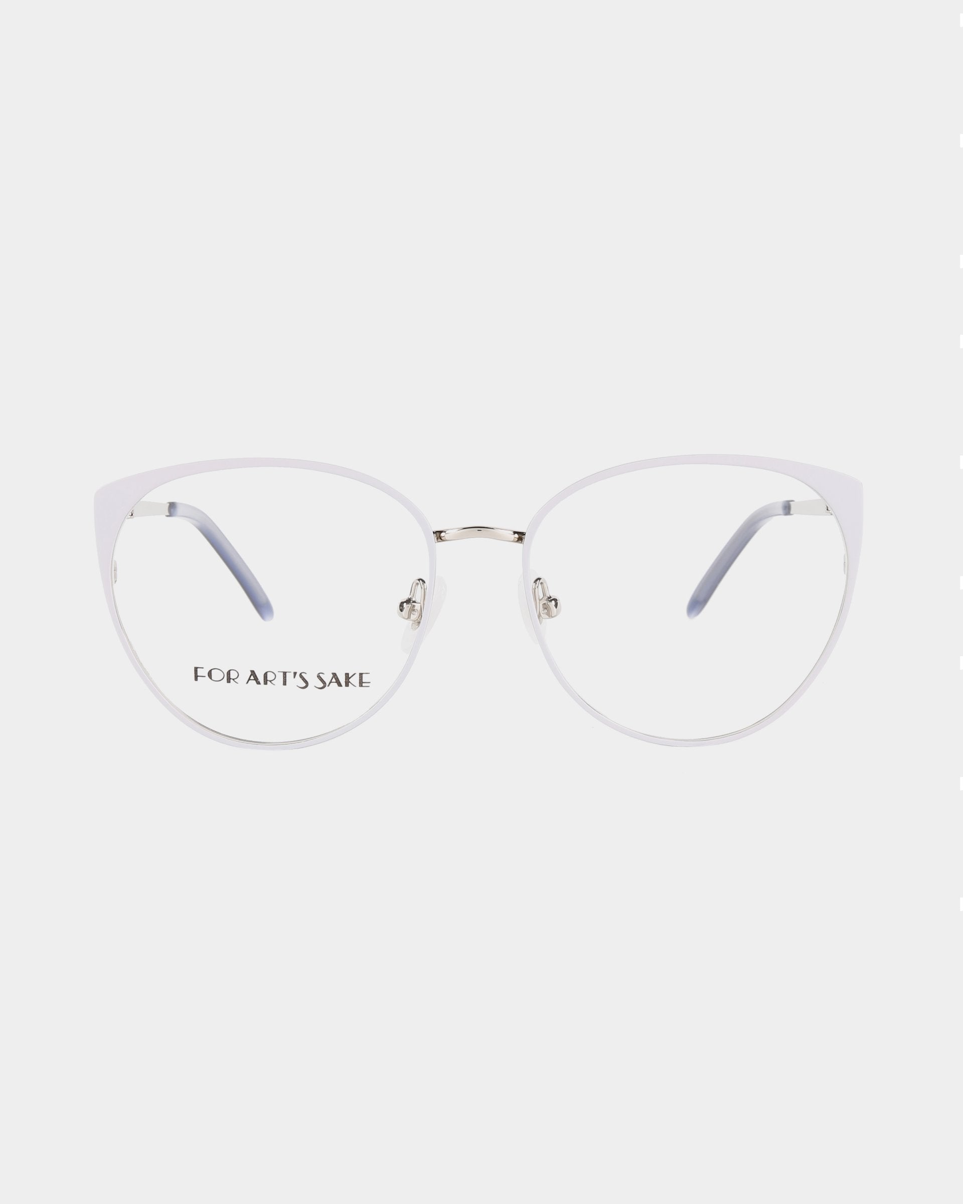 A pair of Kaia glasses by For Art's Sake® with thin, translucent frames and clear lenses that feature a blue light filter. The temples are silver with black tips, adding a touch of elegance. The left lens has the text "FOR ART'S SAKE" printed on it, against a plain white background.