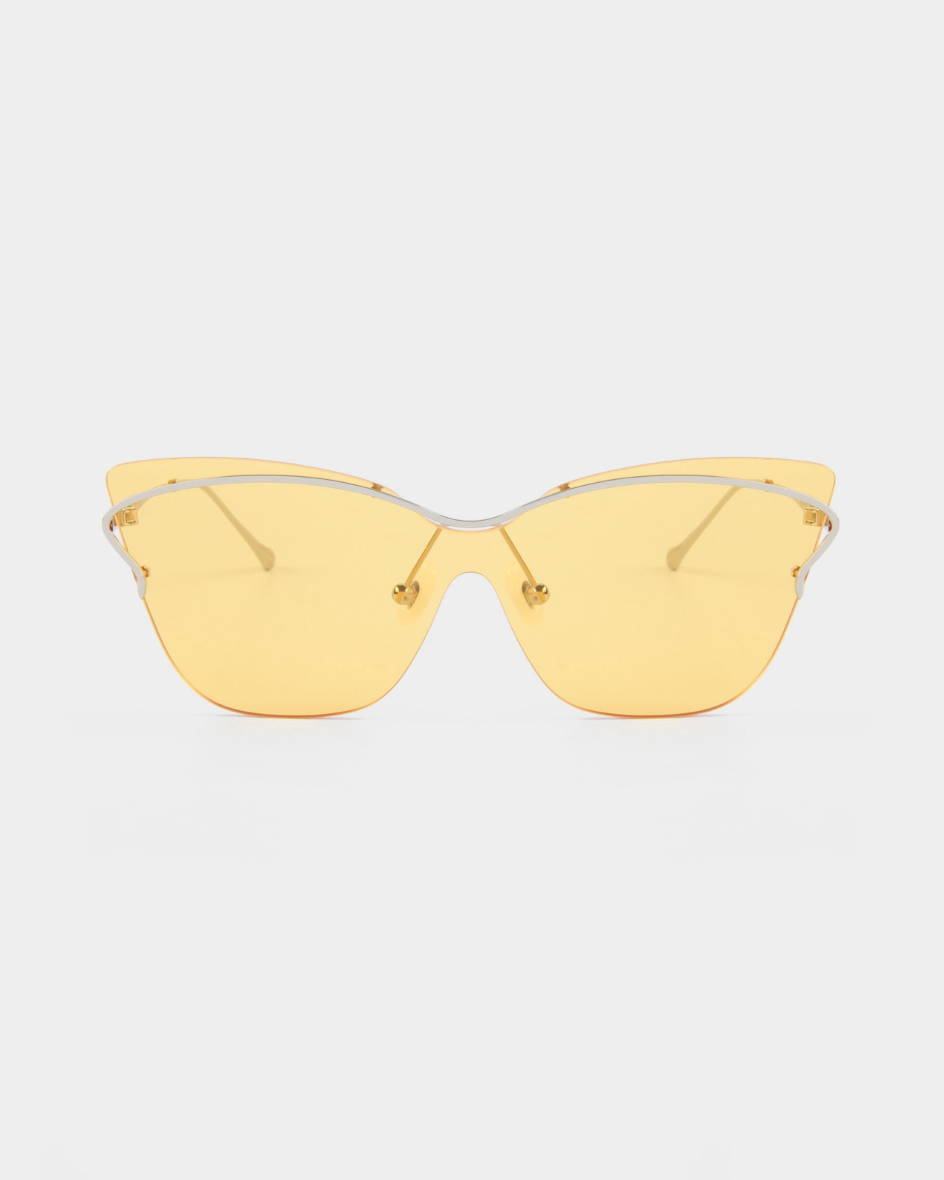 The Kelly sunglasses by For Art's Sake® boast a sleek, retro-futuristic design with yellow lenses and a silver wireframe. The angular, upward-flared lenses evoke the classic cat-eye aviator style, while the thin arms are adorned with minimalistic detailing. Set against a plain white background, these sunglasses truly stand out.