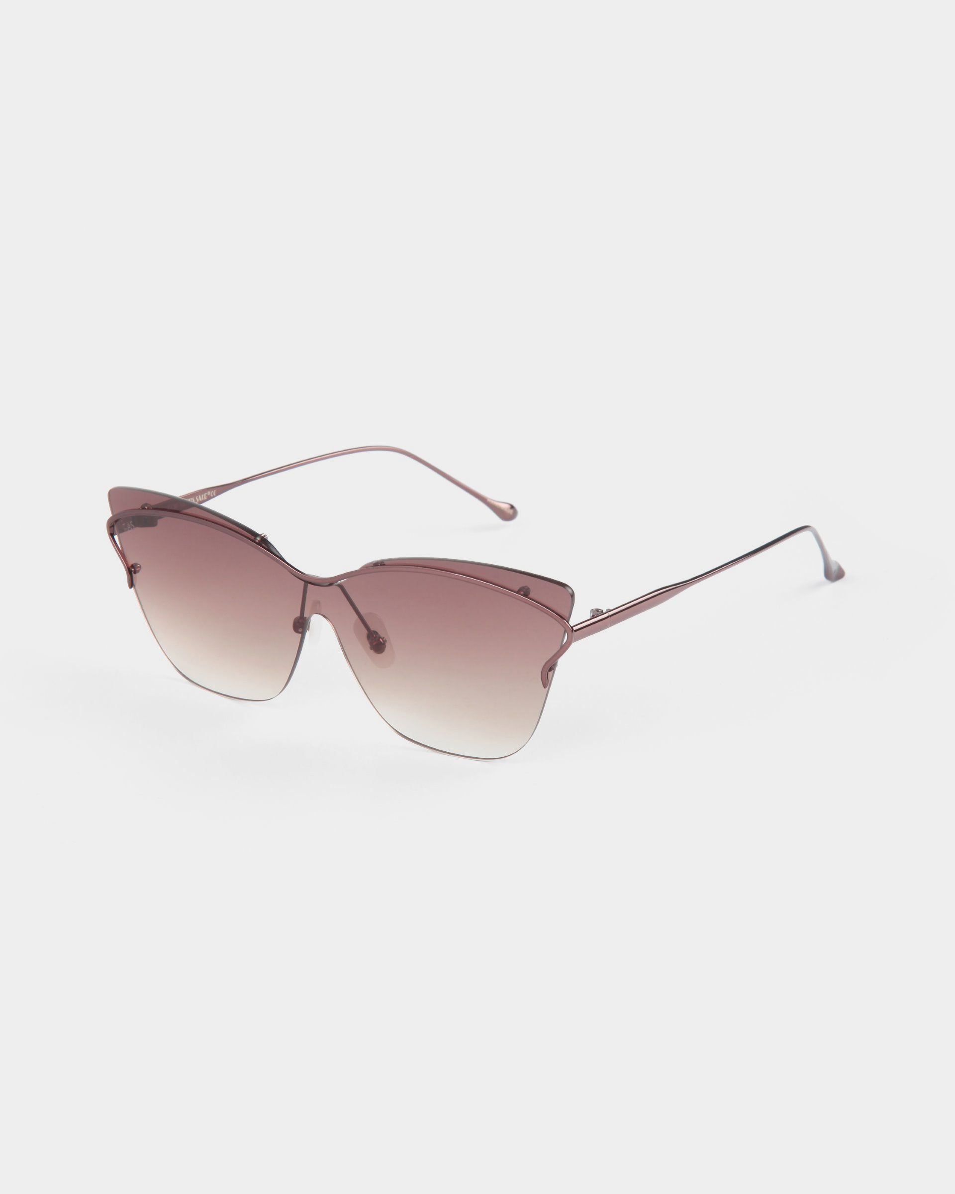 The "Kelly" sunglasses by For Art's Sake® feature a trendy retro-futuristic cat-eye design with brown gradient lenses and slim metal arms. The frame is rimless at the bottom, providing a sleek and modern look ideal for poolside lounging. The background is plain white.