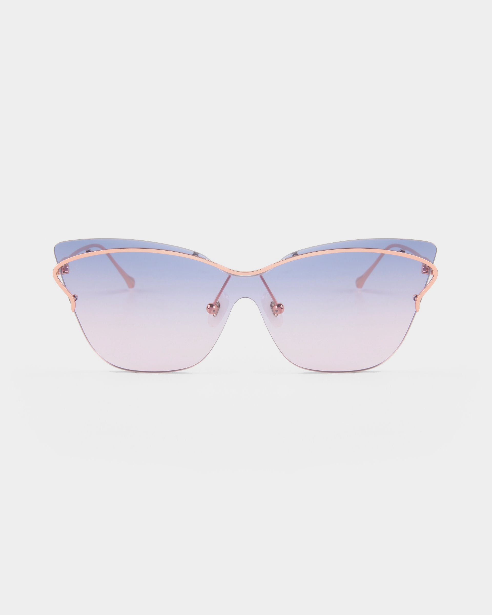 Introducing the Kelly by For Art's Sake®: a pair of stylish, retro-futuristic cat-eye sunglasses featuring gradient lenses that transition from blue at the top to clear at the bottom. These sunglasses boast thin pink metal frames and delicate nose pads for an elegant look.