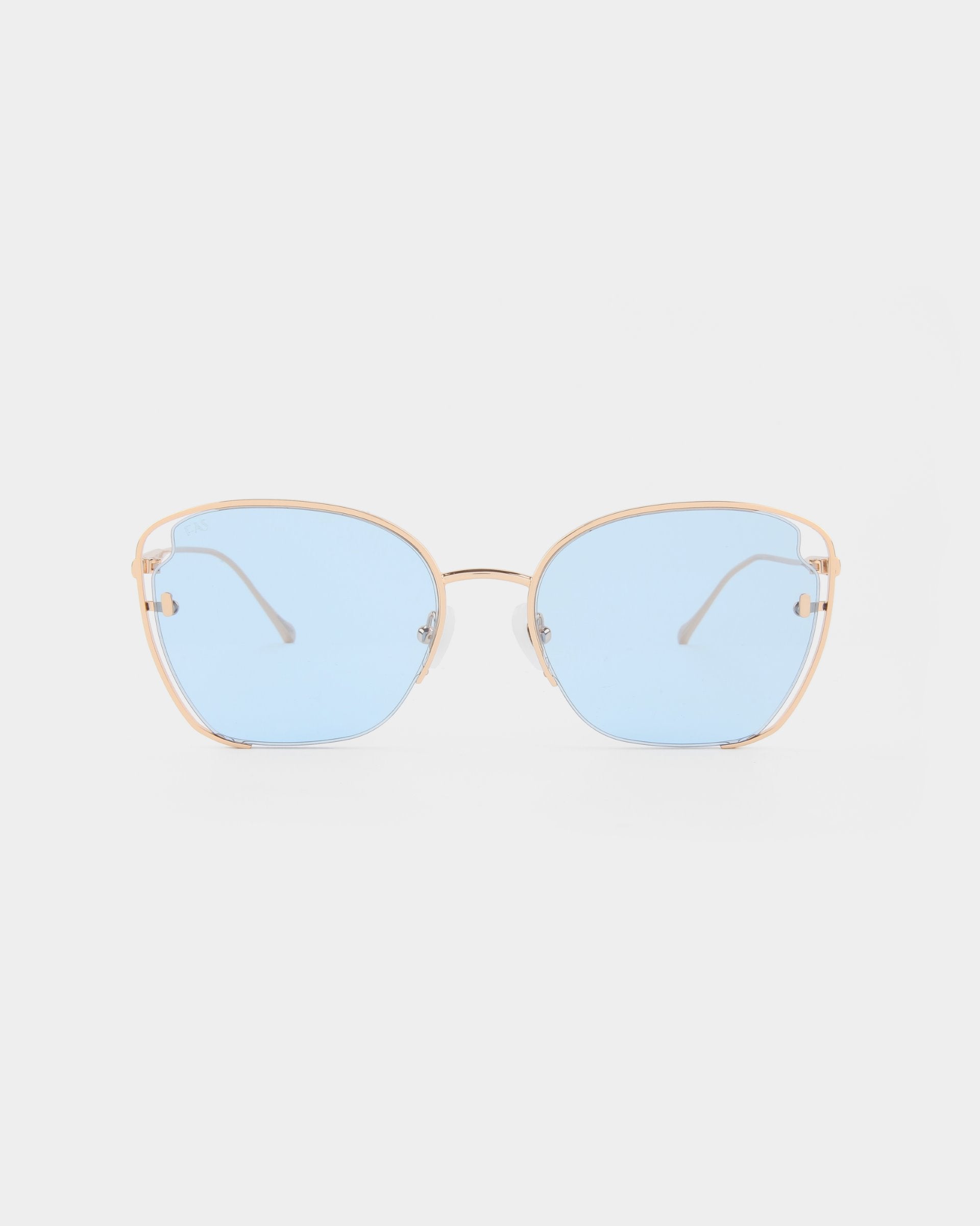Introducing the Eden sunglasses by For Art&#39;s Sake®, a pair of stylish shades featuring 18-karat gold plated metal frames and light blue UVA &amp; UVB-protected lenses. The design sports slightly rounded square lenses, with a thin, delicate nose bridge and temples that add an elegant touch to the overall appearance.