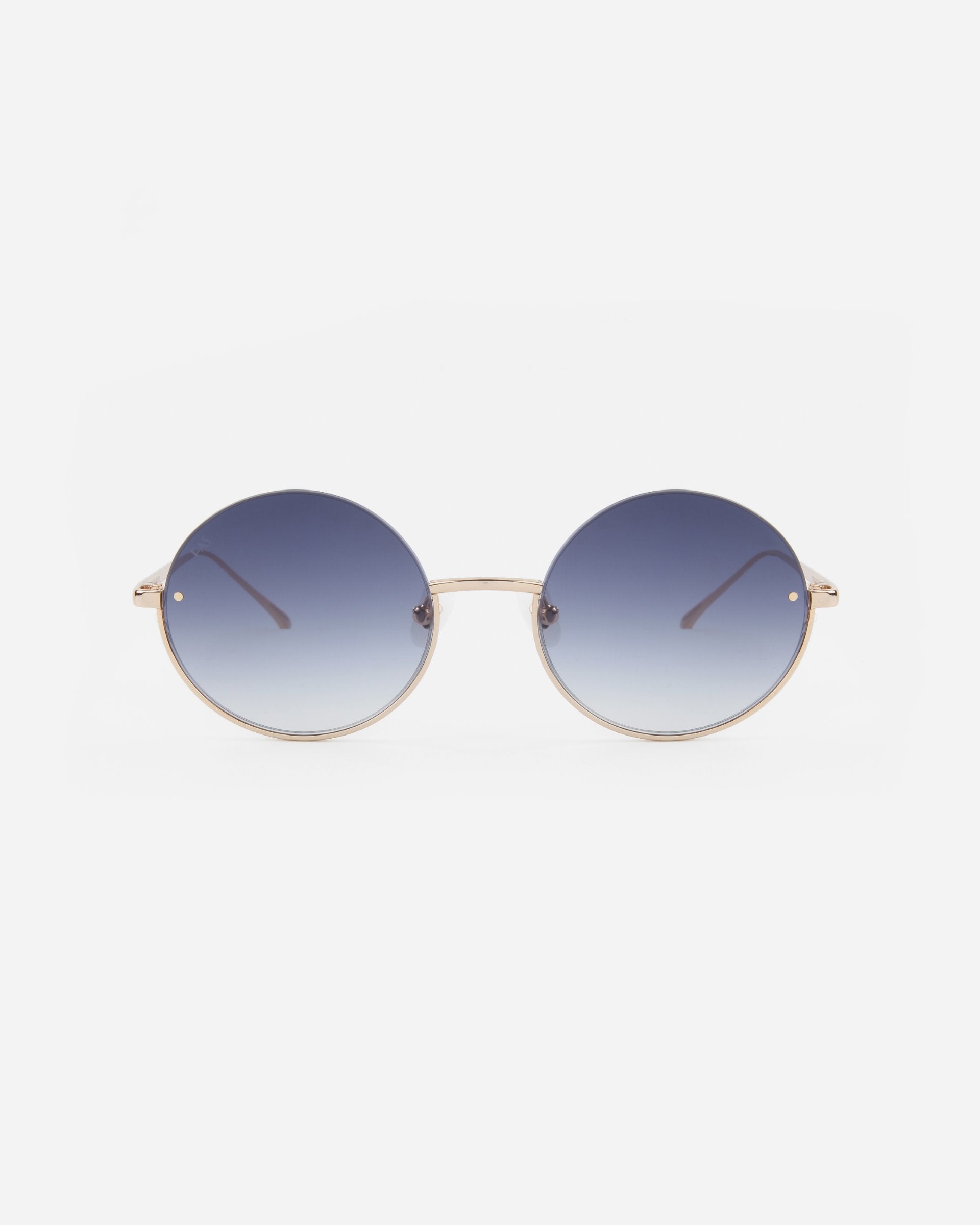 A pair of Skyline sunglasses by For Art&#39;s Sake® with gradient nylon lenses fading from dark blue at the top to clear at the bottom. The gold plated stainless steel frames are thin and metallic, featuring a minimalist design with no visible brand markings. These UVA &amp; UVB-protected sunglasses are set against a plain white background.
