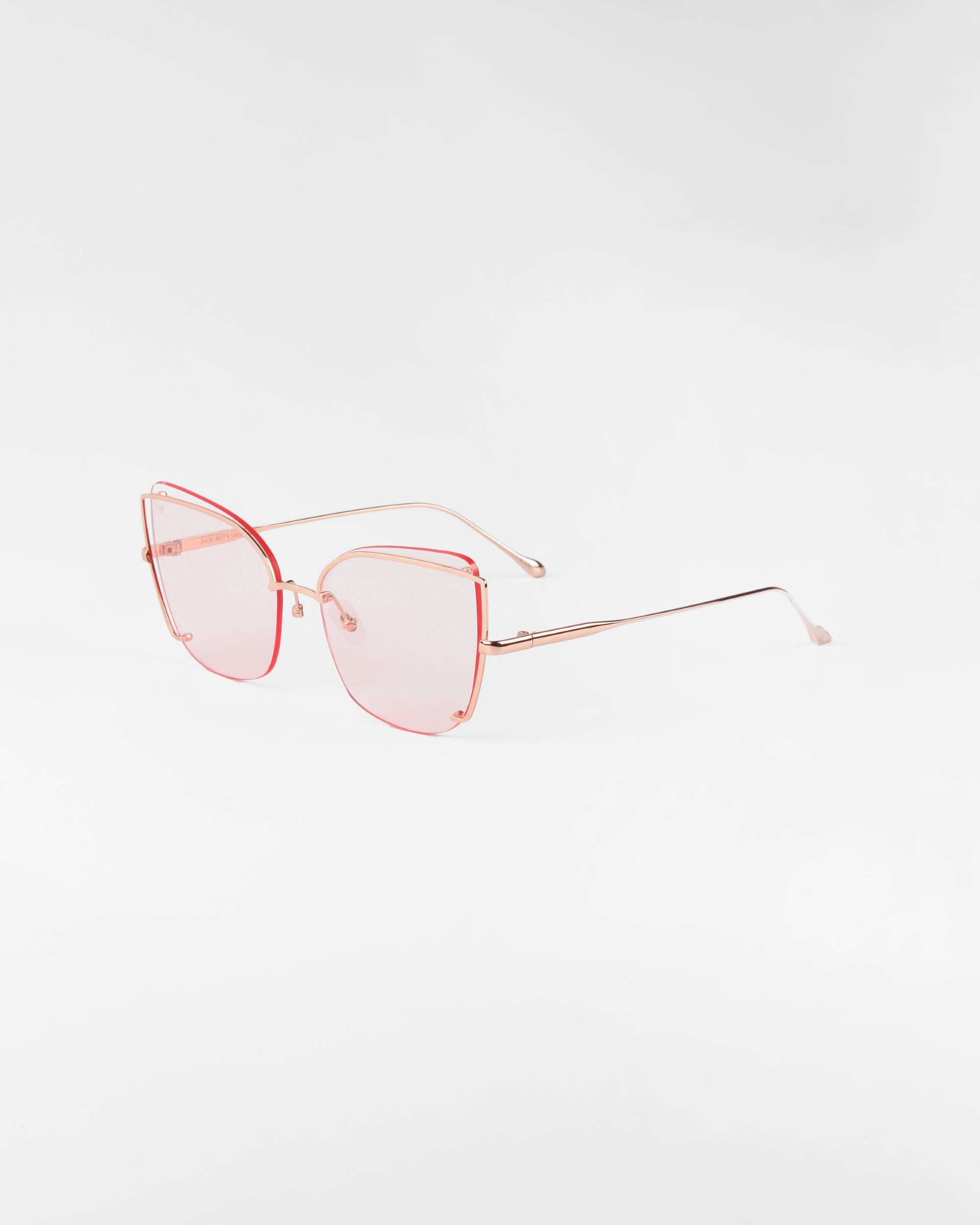 A pair of Meow sunglasses by For Art&#39;s Sake® showcasing pink-tinted nylon lenses and thin stainless steel frames with adjustable nosepads, positioned at an angle against a plain white background.