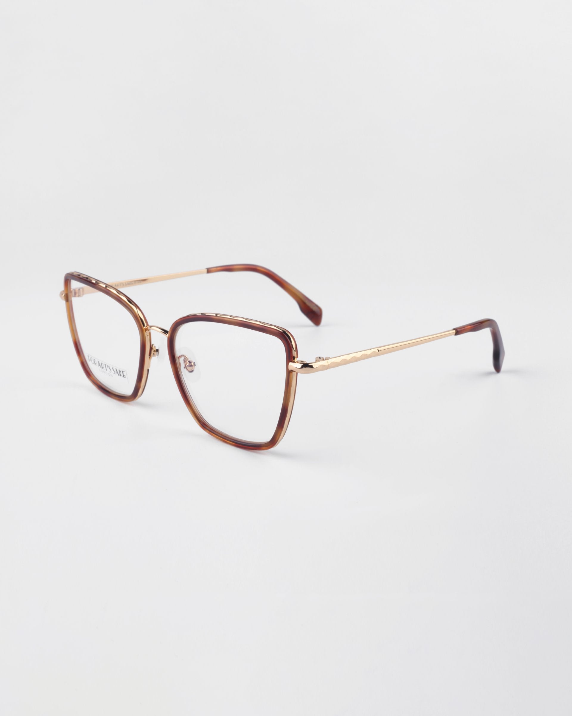 A pair of eyeglasses with a brown square frame and gold-toned temples. The design features a sleek and modern look, enhanced by prescription lenses, and they are positioned on a plain white background. This is the Lace by For Art&#39;s Sake®.