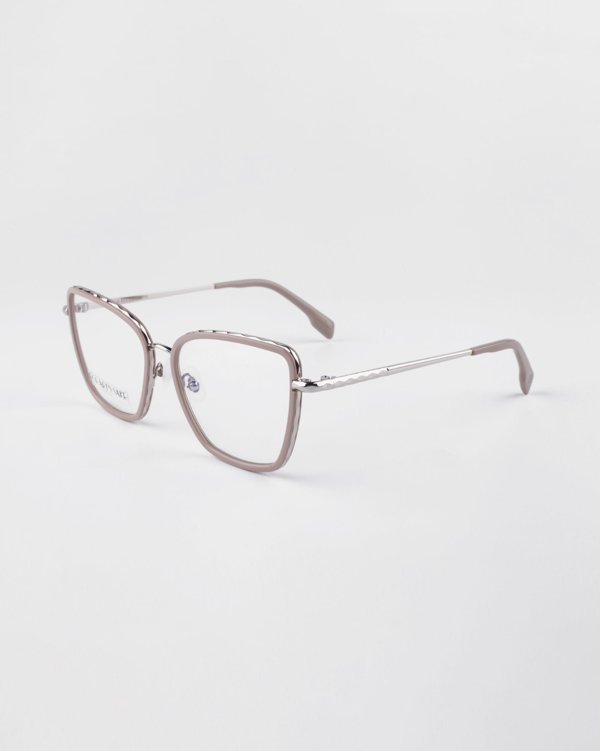 A pair of Lace eyeglasses from For Art&#39;s Sake® with transparent gray frames, thin silver temples, and a blue light filter. The lenses are clear, and the nose pads are adjustable. The background is solid white, showcasing the glasses from a three-quarter angle.