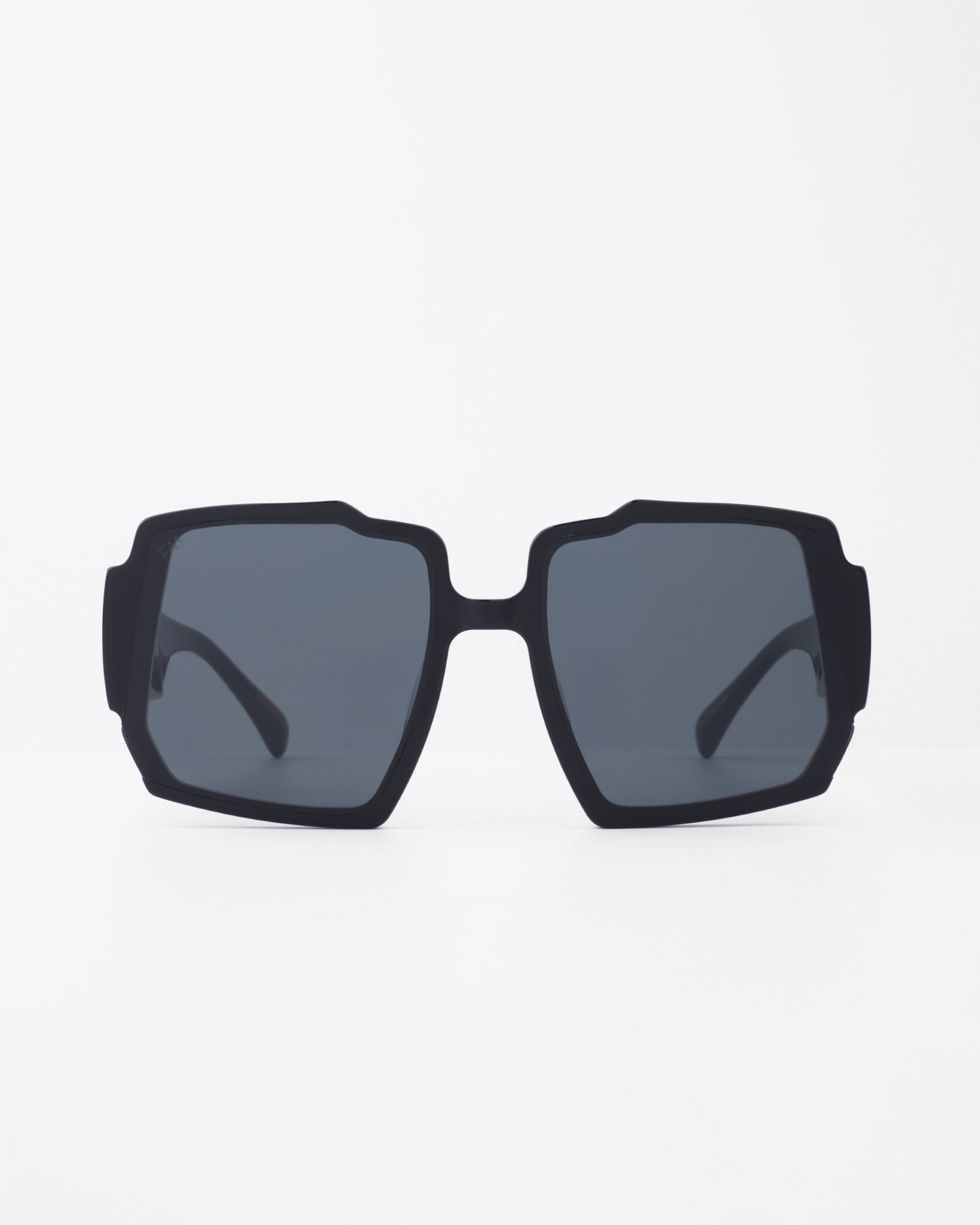 A pair of black, square-shaped For Art's Sake® Moritz sunglasses with chunky acetate frames and UV-protected dark lenses is displayed against a plain white background.