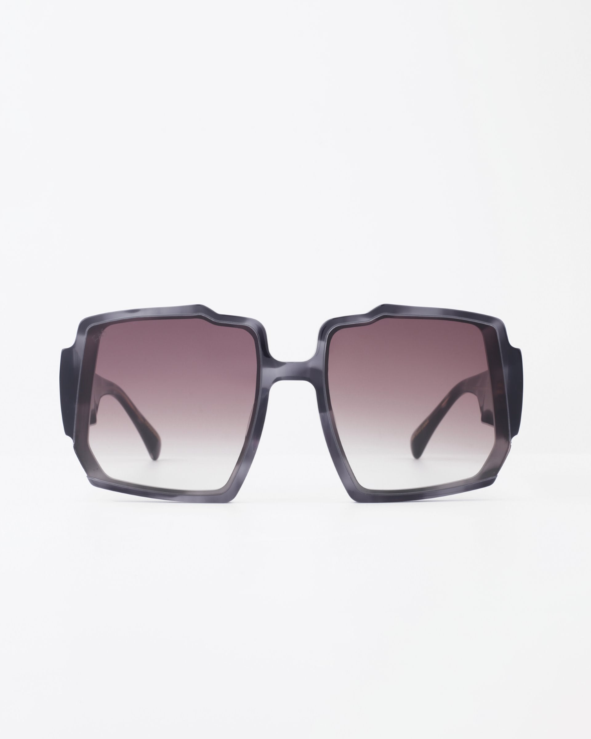 A pair of large, square-framed sunglasses with a dark gradient tint, featuring thick black rims and broad temples. The bold, modern design of the Moritz by For Art's Sake® is enhanced by UV-protected lenses and photographed against a plain white background to highlight their chunky acetate frame.