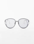 A pair of modern, round, gray Mars eyeglasses from For Art's Sake® with translucent, shatter-resistant nylon lenses and white accents on the temples. The sleek and minimalistic frame is crafted from gold-plated stainless steel, set against a plain white background.