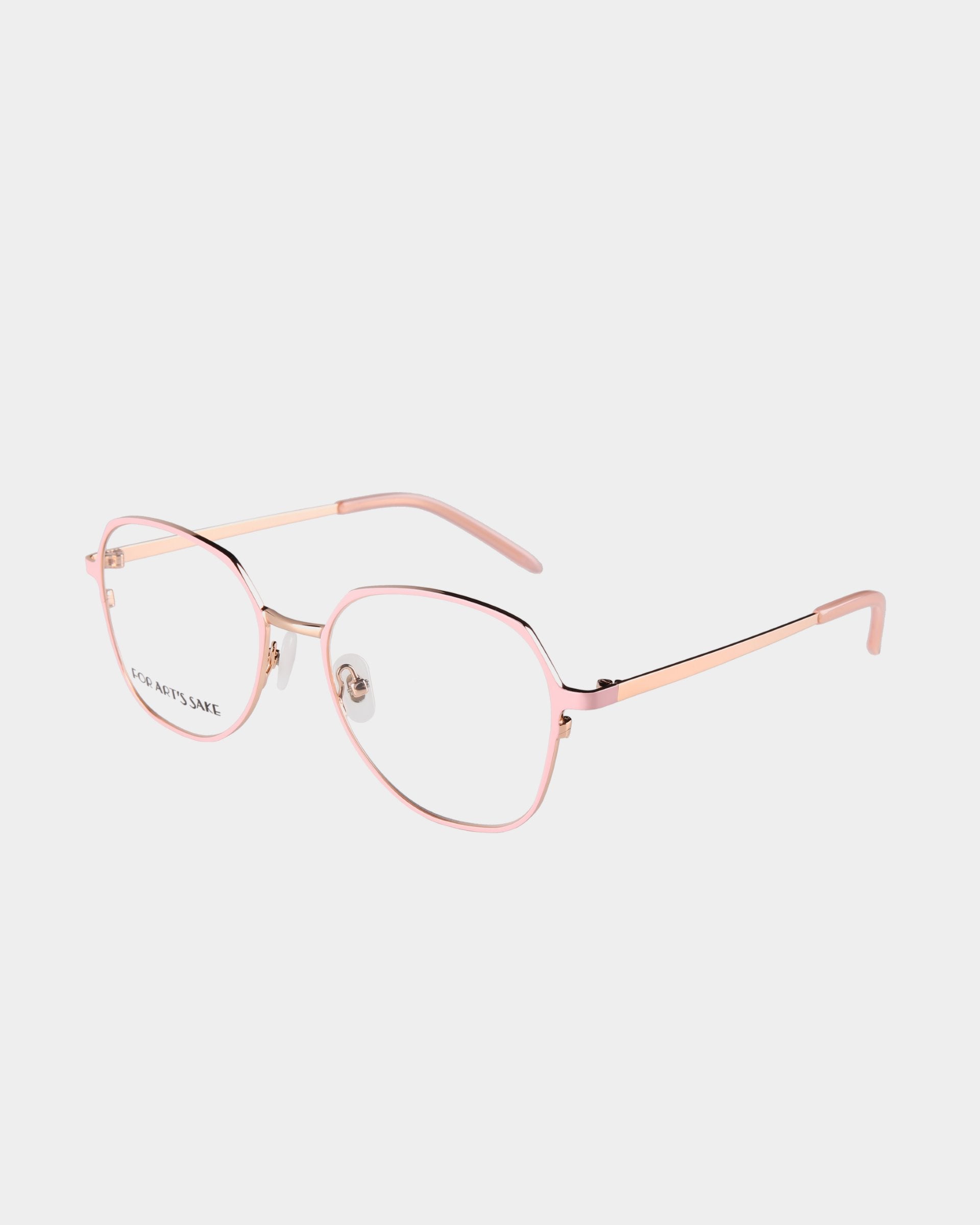 The For Art's Sake® Mila Pink glasses feature a modern design with pink-rimmed hexagonal frames, thin golden temples, and clear lenses on a white background. They include adjustable jade stone nose pads for comfort.