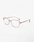 A pair of eyeglasses with a transparent pinkish-brown frame. The lenses feature a blue light filter, and the arms have a subtle golden detail near the hinges. The Mimosa by For Art's Sake®, with their gold-plated frames, are set against a plain white background.