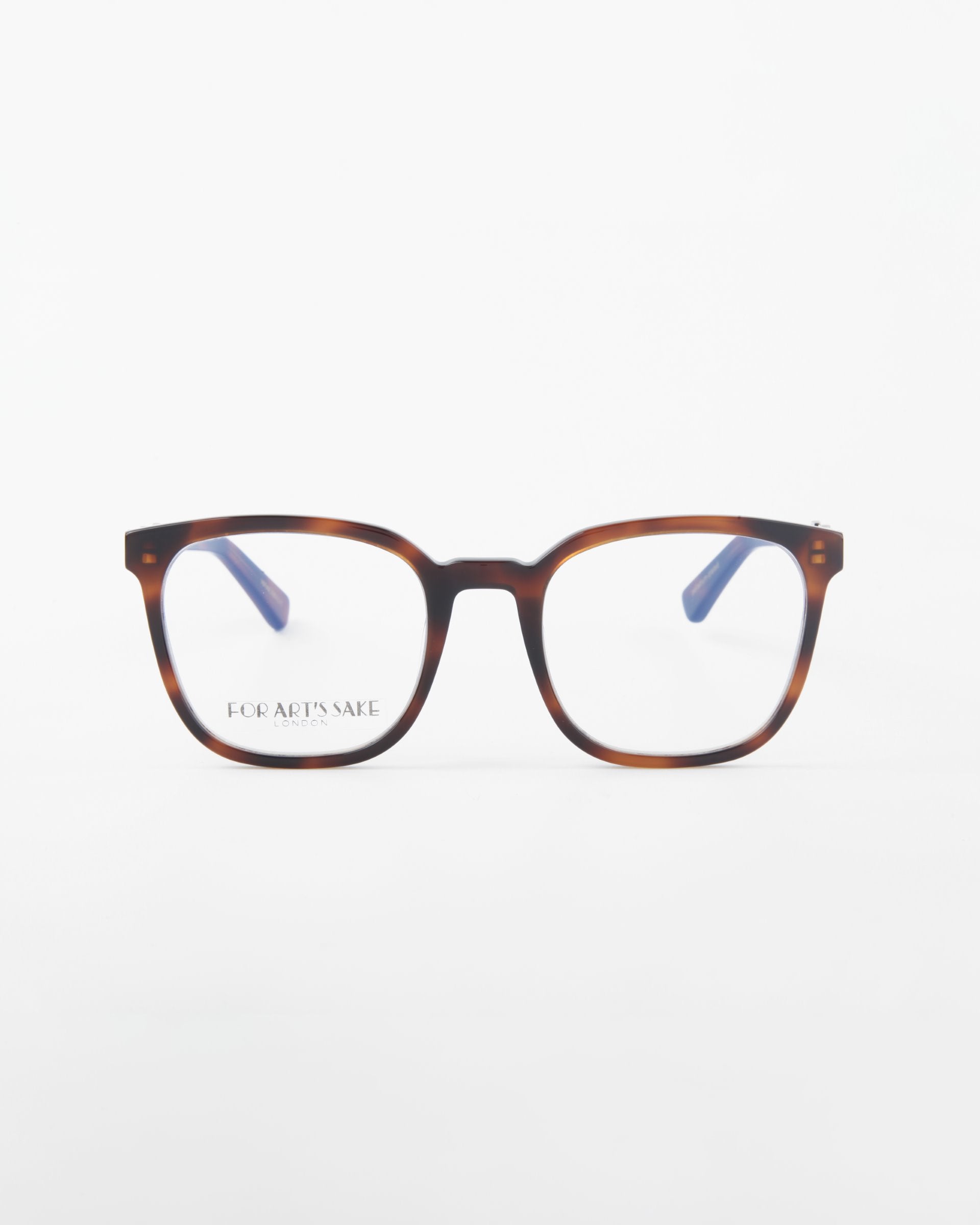 A pair of brown tortoiseshell rectangular eyeglasses with blue-tinted arms is displayed against a plain white background. Made from plant-based acetate, the phrase &quot;FOR ART&#39;S SAKE&quot; is visible on one of the lenses, highlighting their eco-friendly appeal. The model name for these eyeglasses is Molten by For Art&#39;s Sake®.
