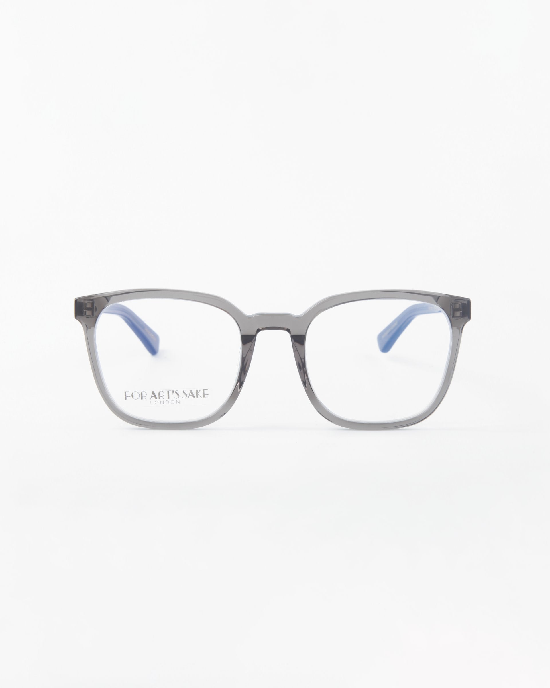 A pair of rectangular eyeglasses with transparent gray frames and light blue temple tips, placed on a white background. Made from plant-based acetate, the product name &quot;Molten&quot; and brand name &quot;For Art&#39;s Sake®&quot; are printed on the left lens.