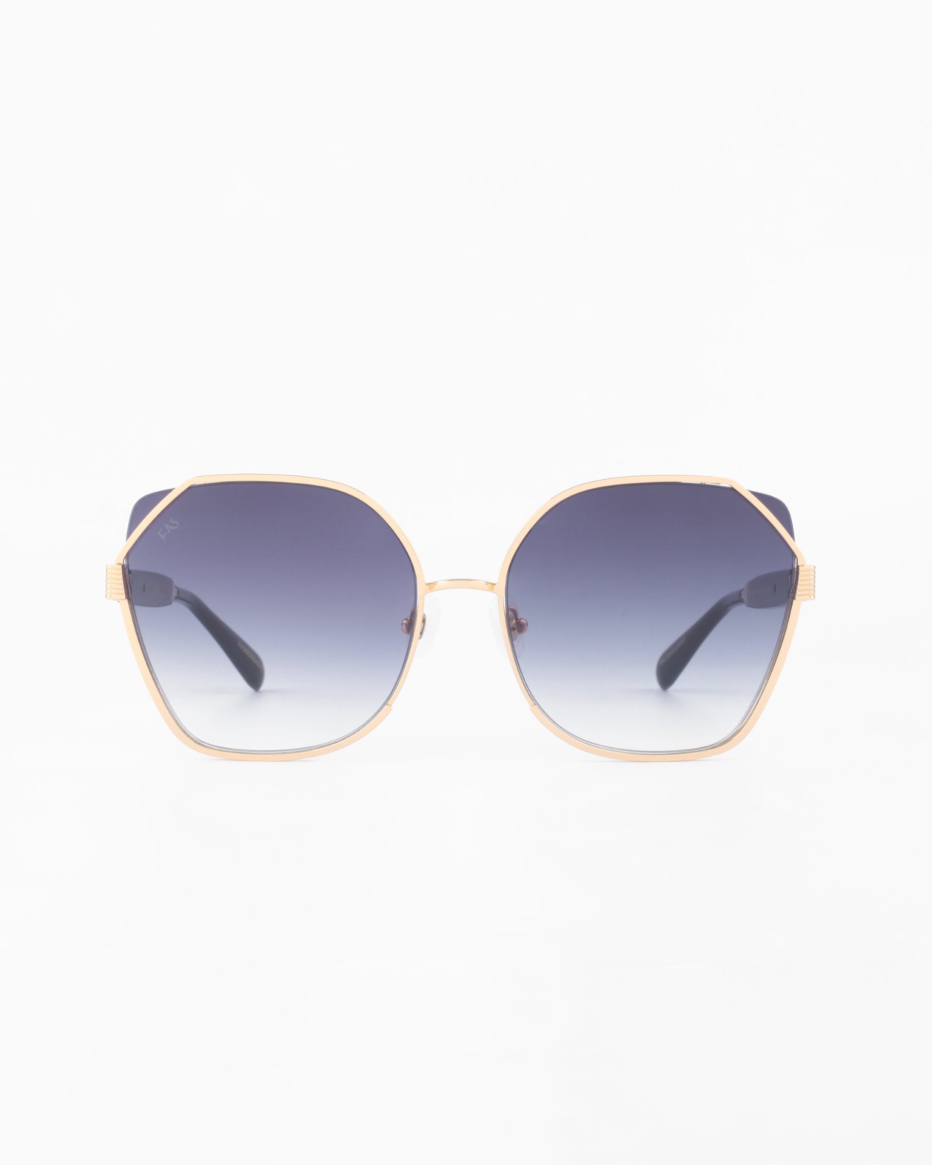 A pair of stylish For Art&#39;s Sake® Montage sunglasses with gold-plated stainless steel hexagonal frames and gradient ultra-lightweight Nylon lenses that transition from dark at the top to lighter at the bottom. The temples are black, and the overall design is sleek and modern against a plain white background.