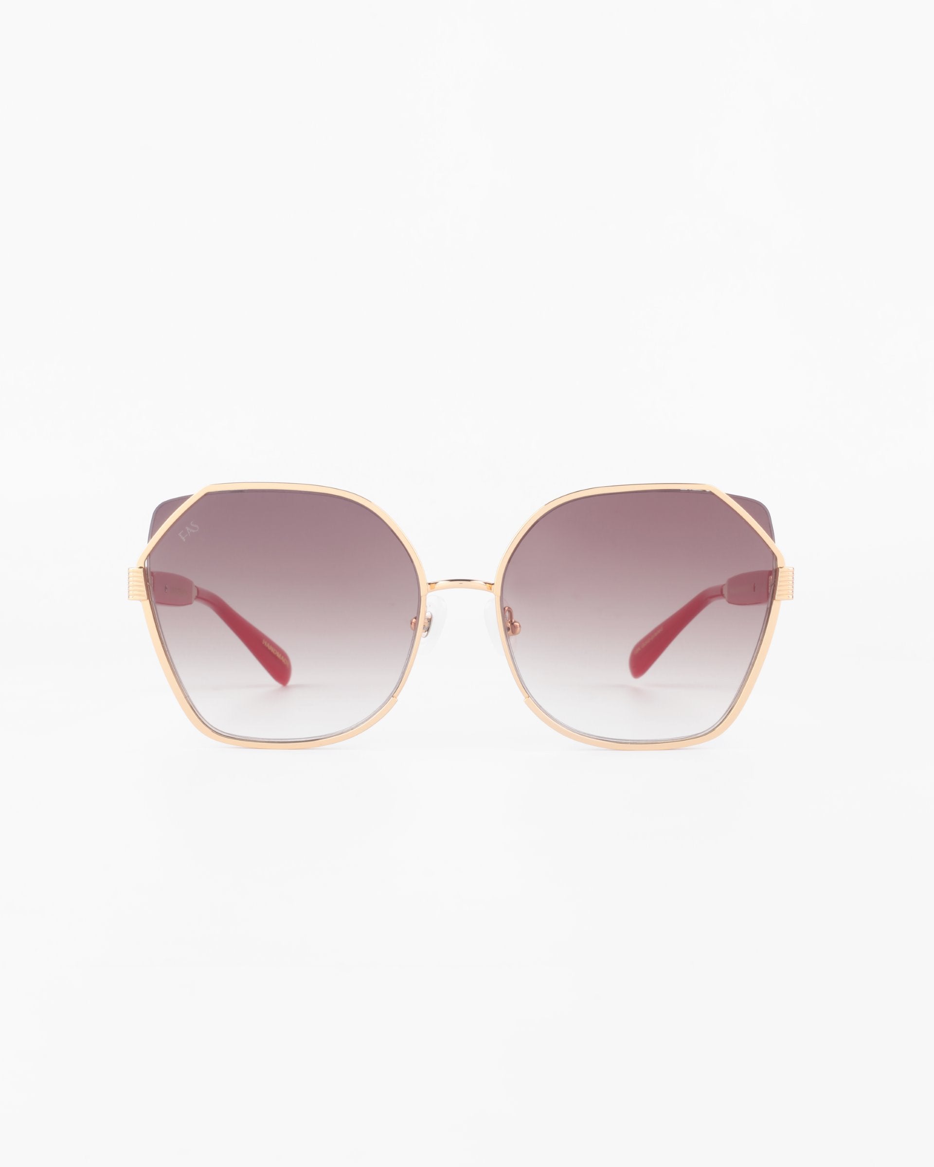 A pair of large, octagonal sunglasses with a gold-plated stainless steel frame and ultra-lightweight nylon lenses that transition from dark at the top to lighter at the bottom. The red-armed Montage by For Art&#39;s Sake® offer 100% UVA &amp; UVB protection. The background is plain white.