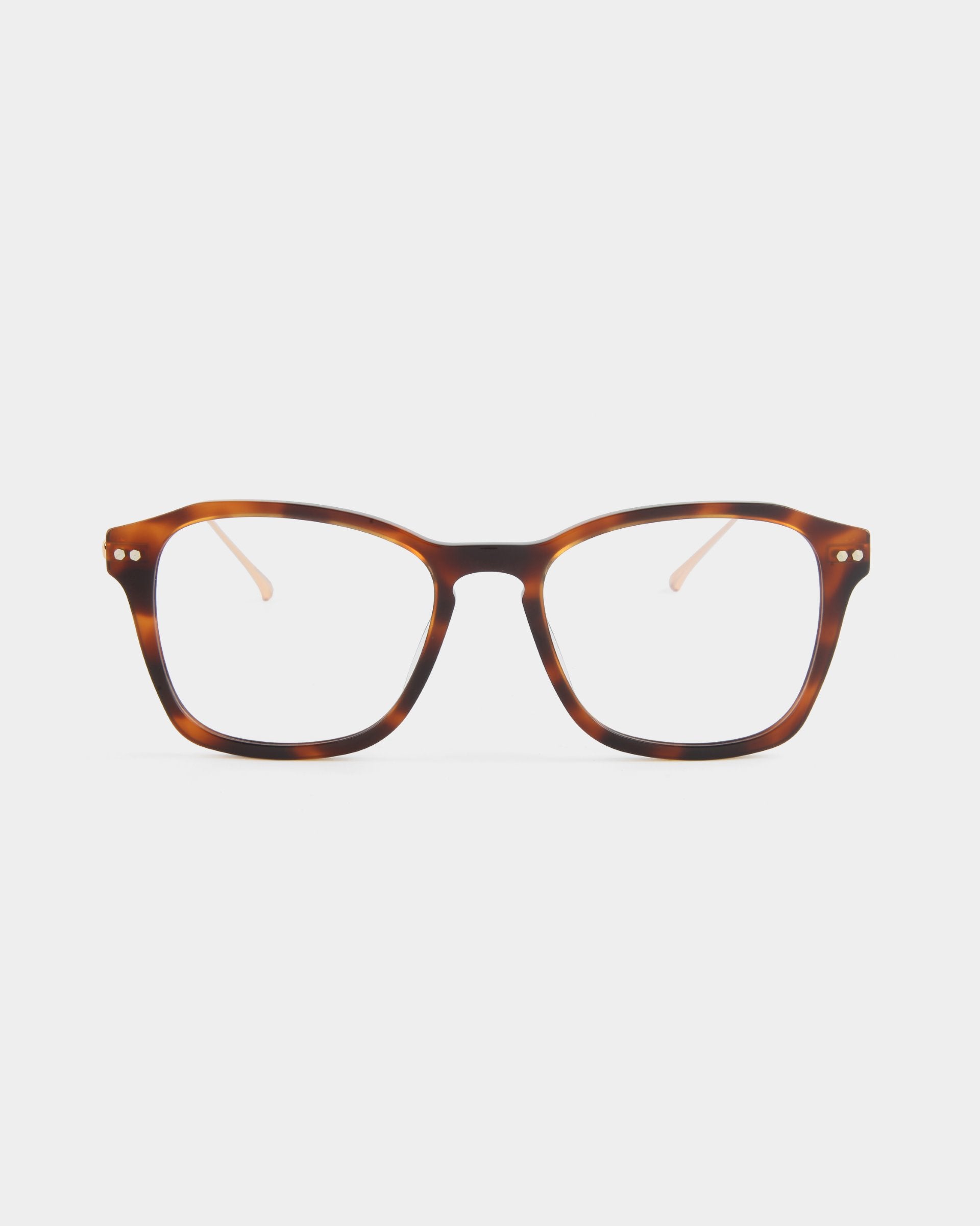 A pair of rectangular, brown tortoiseshell eyeglasses with clear lenses is centered against a plain white background. The frames have small silver embellishments near the hinges on the front and feature adjustable nose pads for comfort. These stylish Morris glasses by For Art&#39;s Sake® are perfect for those seeking prescription service.