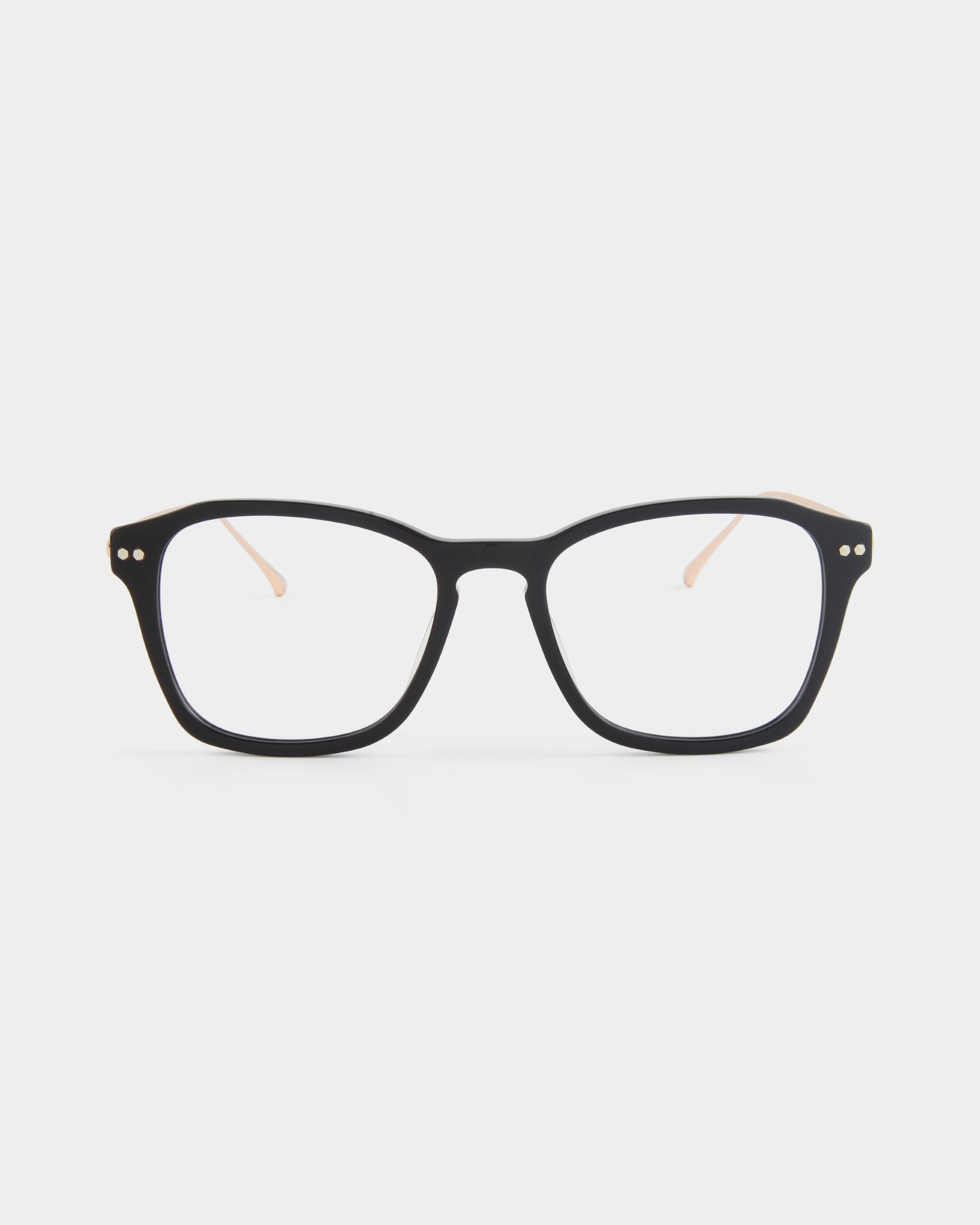 Black rectangular eyeglasses, named &quot;Morris&quot; by For Art&#39;s Sake®, with a glossy finish are shown against a plain white background. The glasses feature subtle metallic details on the upper corners of the stainless steel frames and thin, light-colored temple arms.