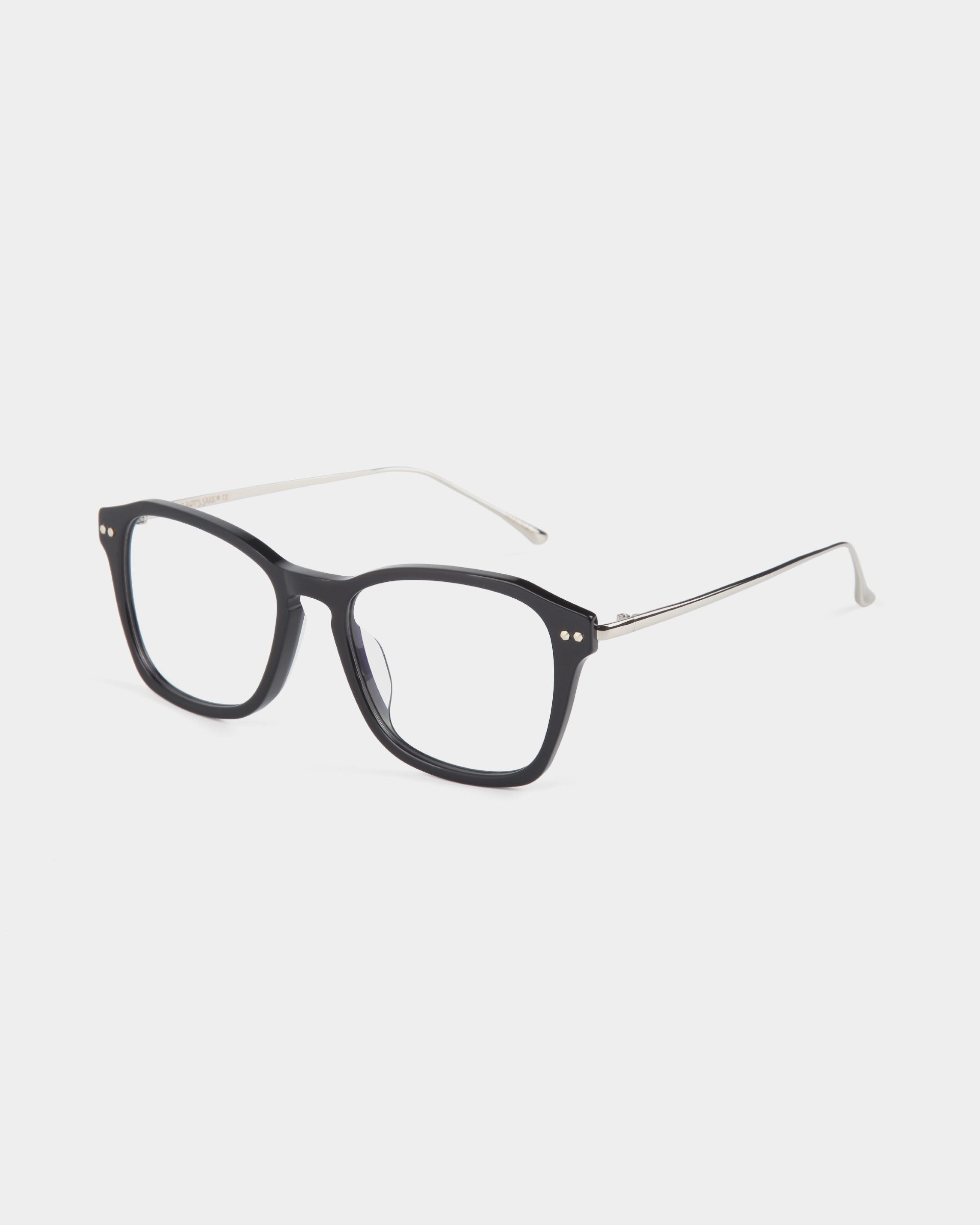 A pair of eyeglasses with black rectangular frames and silver temples is shown against a plain white background. The For Art&#39;s Sake® Morris glasses, featuring stainless steel frames, have clear lenses and small silver dots on the front edges near the hinges.