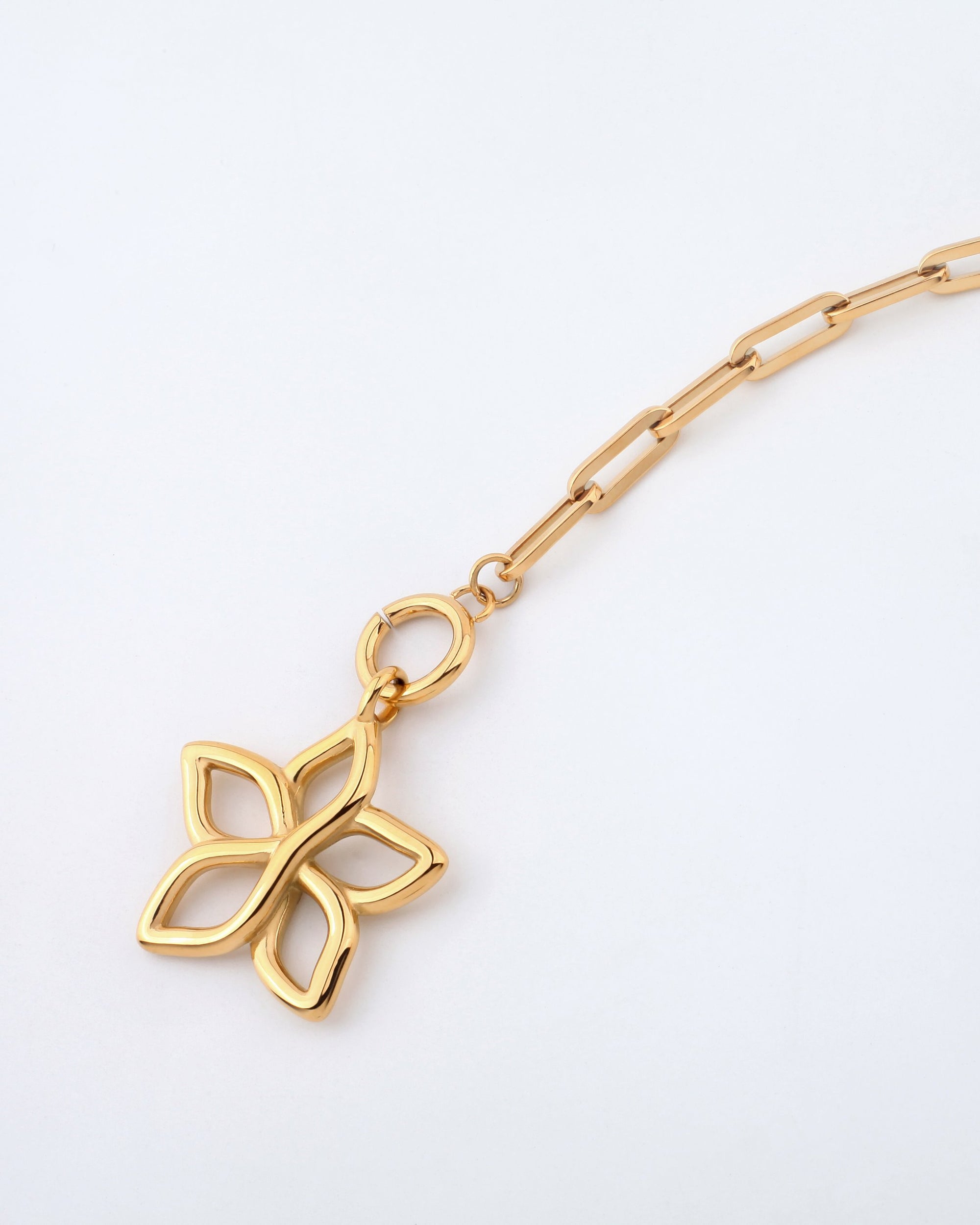 A close-up image of the 49cm Plumeria Necklace by For Art&#39;s Sake®, showcasing its elegant gold chain link design and a pendant shaped like a four-petal flower with open spaces inside each petal, set against a plain white background.