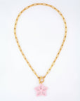 The Plumeria Necklace by For Art's Sake® features a gold chain with elongated rectangular links and a 49cm length. This elegant piece includes a toggle clasp and is adorned with a pastel pink butterfly-shaped pendant, embodying minimalistic sophistication with its striking contrast between the gold chain and the delicate charm.