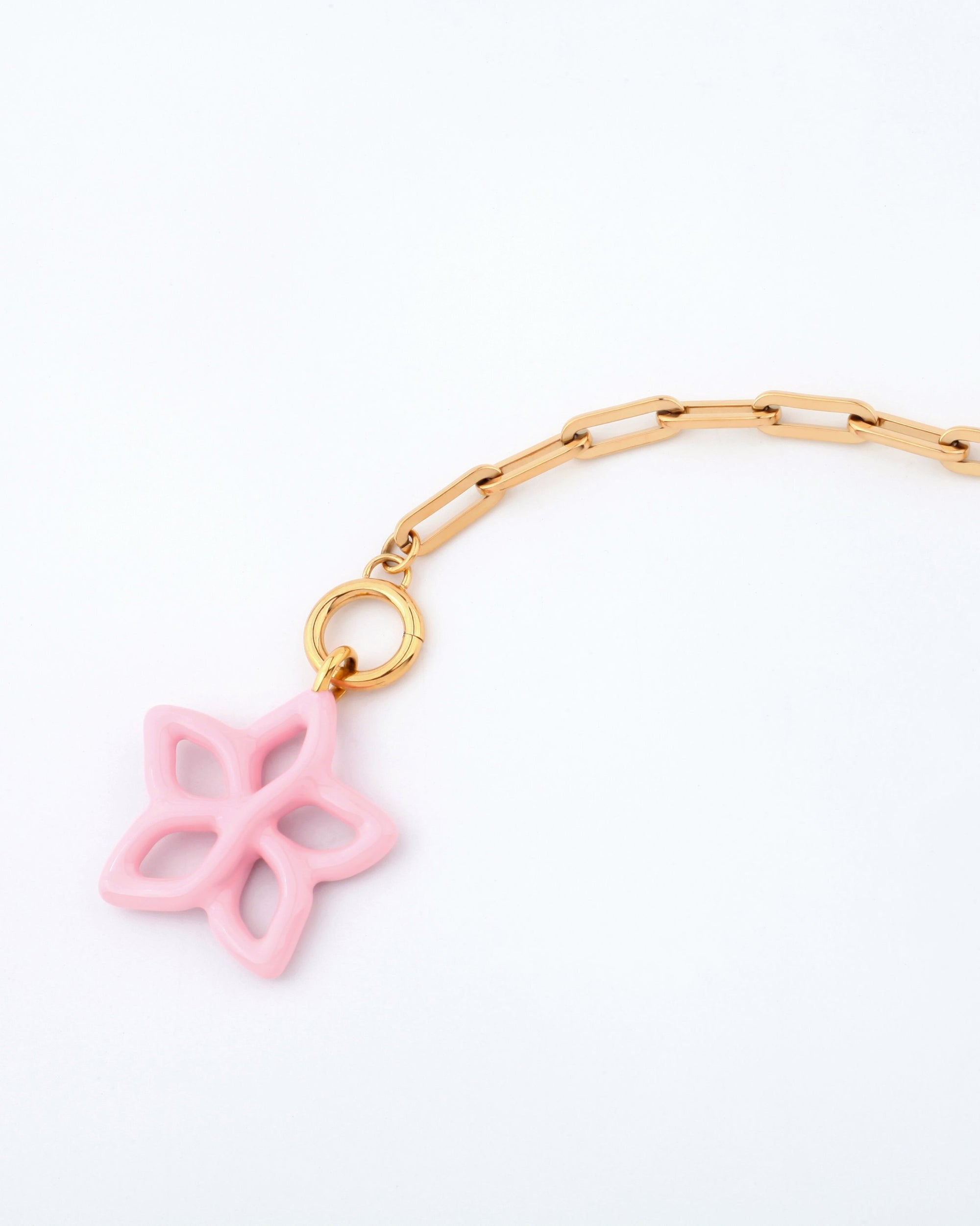 A gold chain link Plumeria Necklace from For Art&#39;s Sake®, featuring a large pink star-shaped charm with a hollow design, rounded edges, and a smooth surface. Measuring 49cm in length, the necklace is minimalist and elegant against a plain white background.