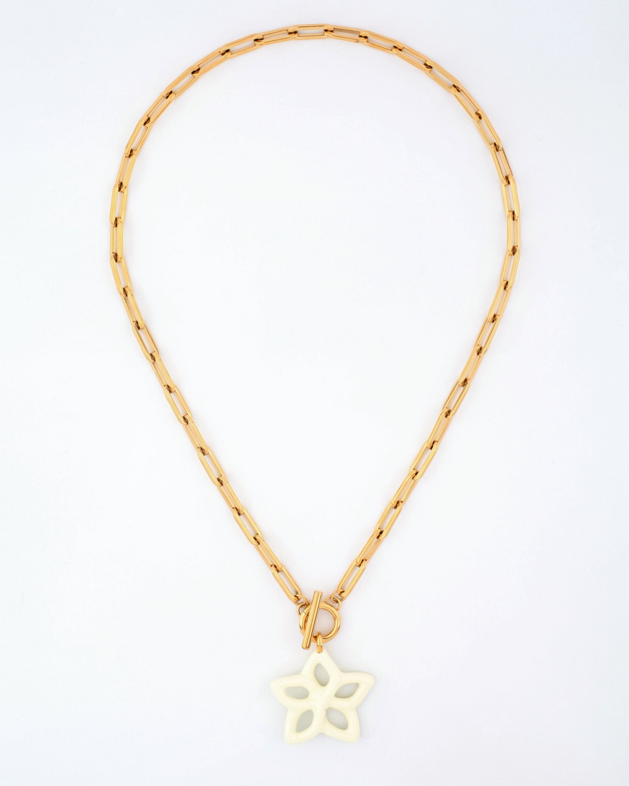 The Plumeria Necklace by For Art's Sake® features a gold chain with elongated rectangular links and a white butterfly-shaped pendant. Measuring 49cm in length, the necklace allows the pendant to hang elegantly at the center of the chain, displayed in a circular form against a white background.