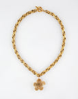 The For Art's Sake® Blossom Necklace showcases a striking gold chain with a rounded link design, adorned at the center with an eye-catching large, gold five-petaled flower charm. Measuring 46cm in length, this necklace features a distinctive T-bar clasp and is set against a plain white background.