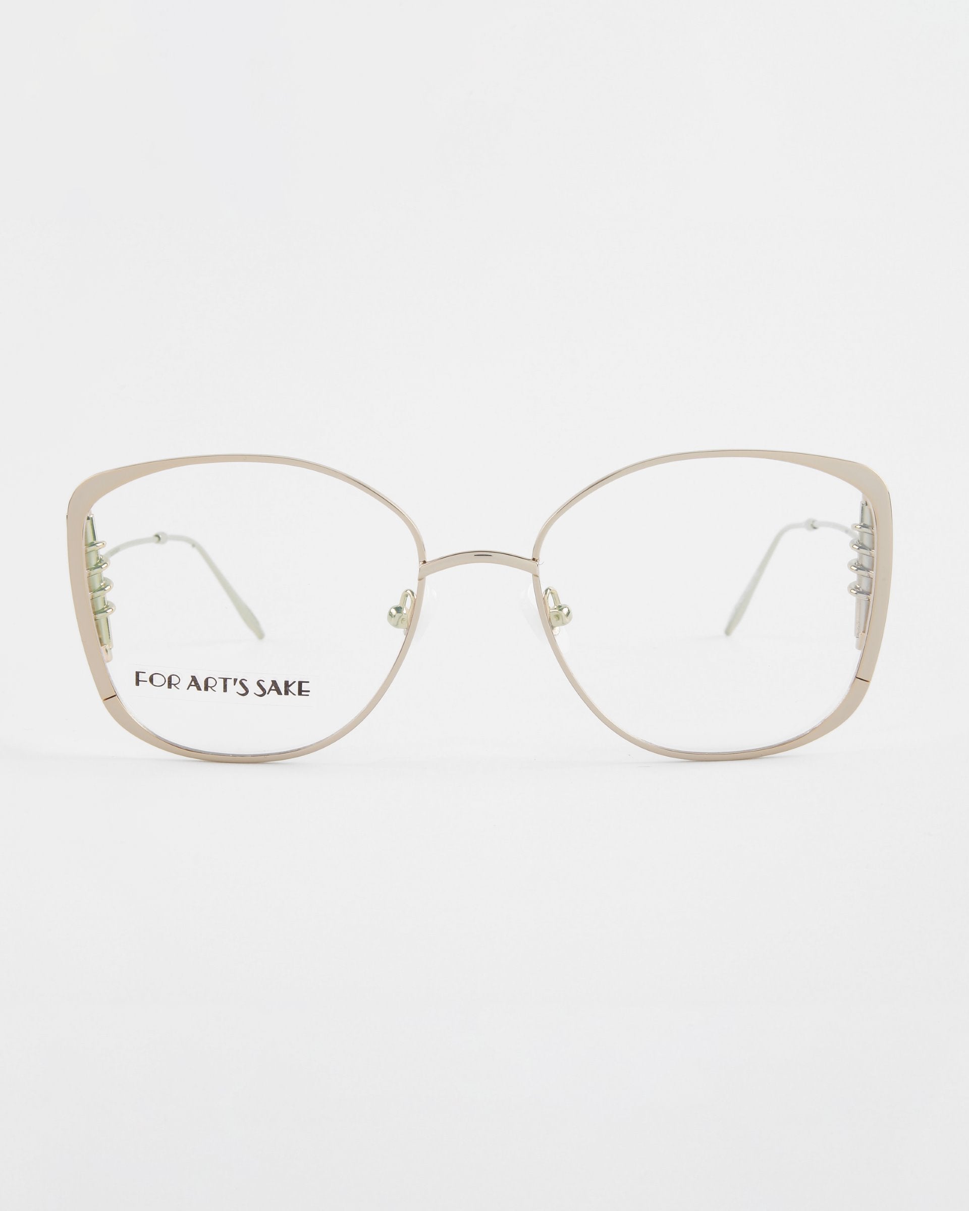 A pair of gold-rimmed eyeglasses with large, square-shaped lenses. The glasses have thin, lightweight frames with 18-karat gold plating and clear lenses. The product name &quot;Jupiter&quot; and the brand name &quot;For Art&#39;s Sake®&quot; are visible on the left lens. The background is white.
