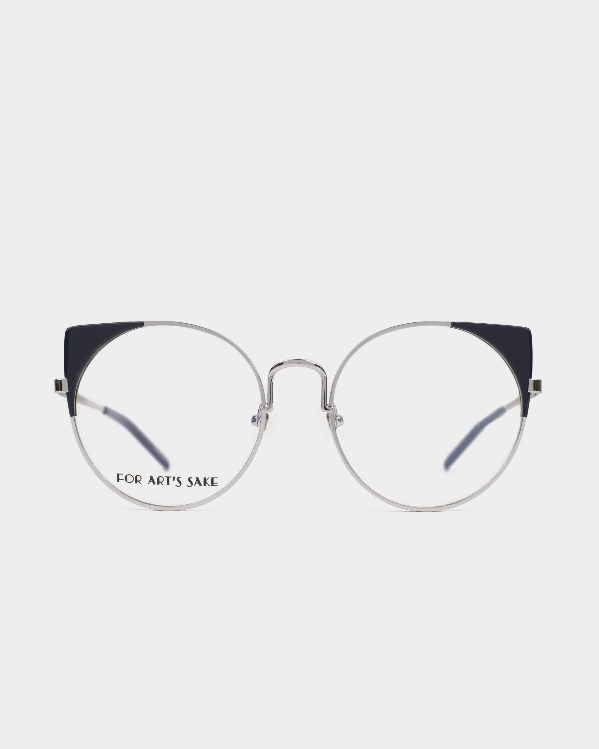 A pair of round, silver-framed Brisky eyeglasses with dark blue accents on the upper corners of the lenses. The left lens has the text &quot;For Art&#39;s Sake®&quot; on it. These stylish glasses also feature a blue light filter for added eye protection. The background is plain white.