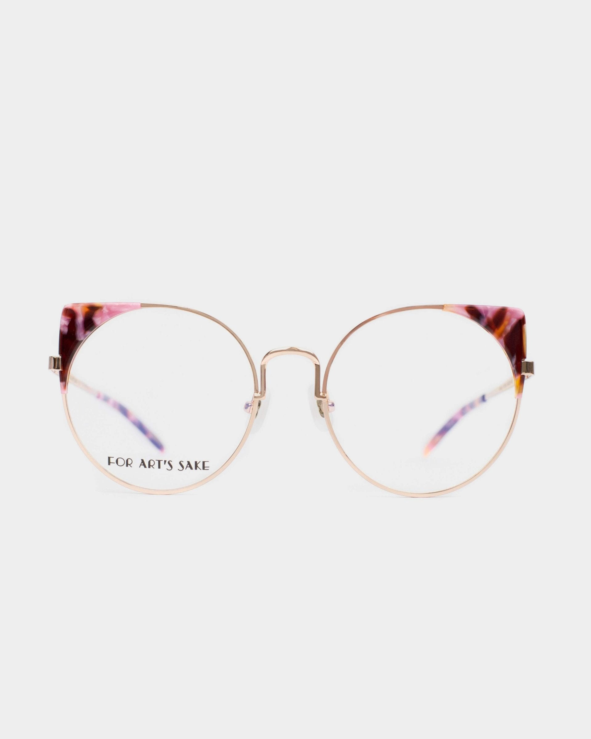 A pair of stylish Brisky eyeglasses with gold metal rims and round lenses. The top part of the frames features a pink and black marbled pattern, and the brand name &quot;For Art&#39;s Sake®&quot; is visible on the left lens. These glasses come with a blue light filter for extra eye protection.