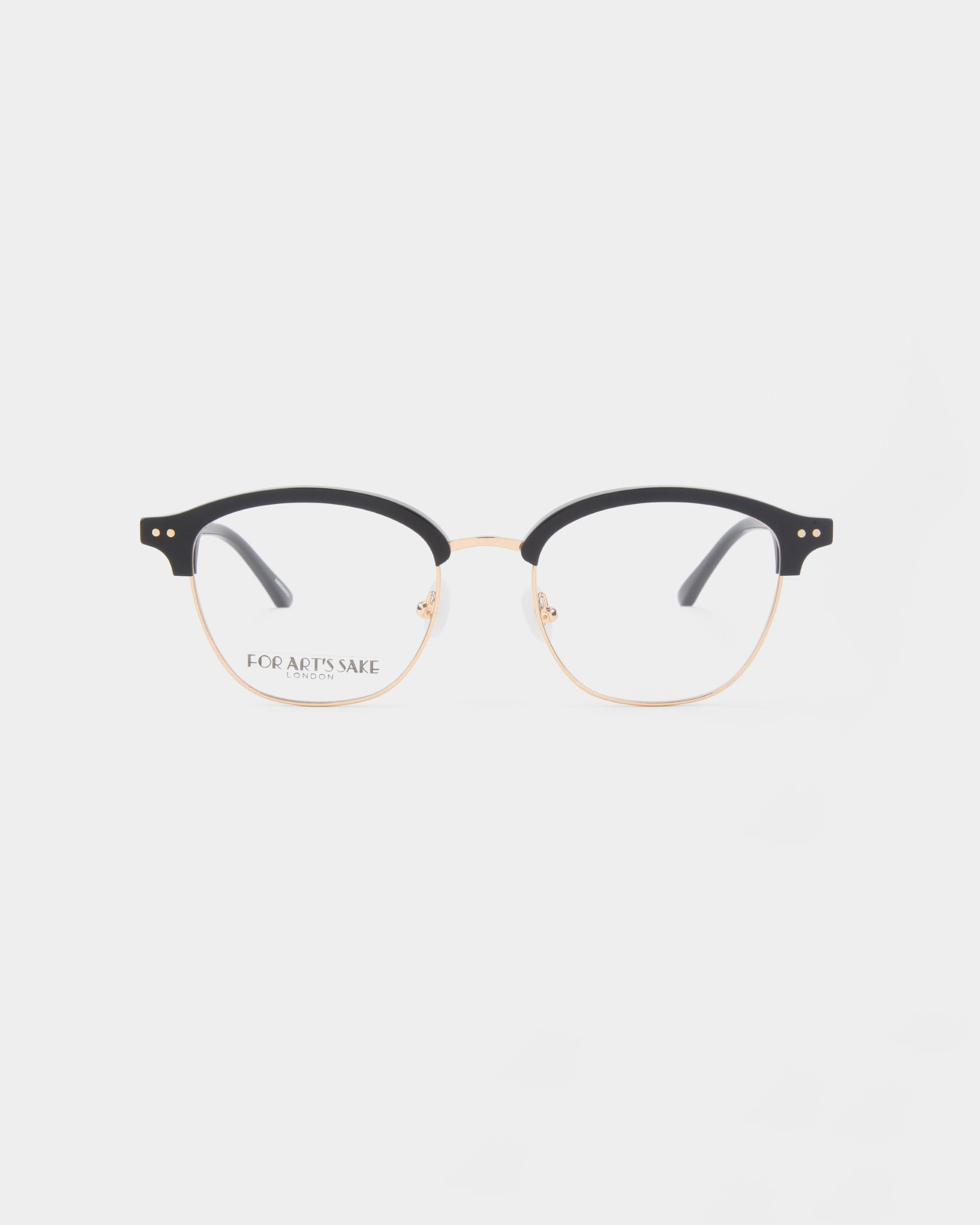 A pair of round Painkiller eyeglasses by For Art&#39;s Sake® featuring a thin, gold metal frame with black accents on the top half of the rims and black temple tips. The clear lenses offer a minimalist design with an optional Blue Light Filter for added comfort. The background is plain white.