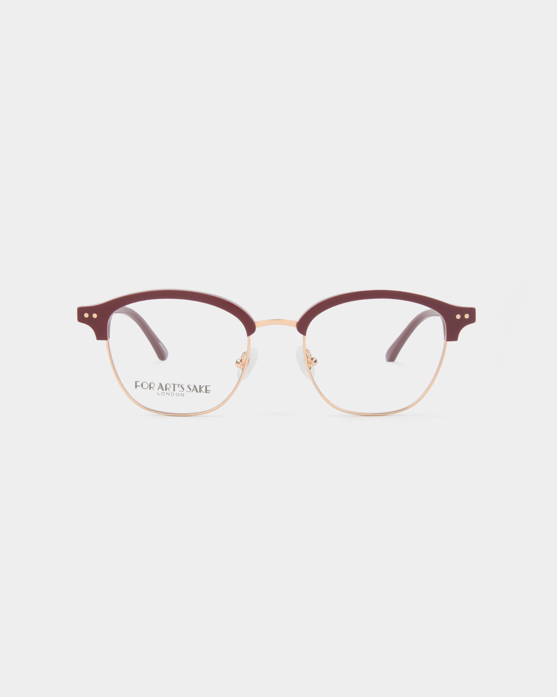 A pair of stylish eyeglasses with burgundy half-rim frames and gold accents on the temples. The clear lenses, featuring a subtle brand logo &quot;For Art&#39;s Sake®&quot; on the left lens, include a blue light filter for added eye comfort. The plain white background highlights the Painkiller beautifully.