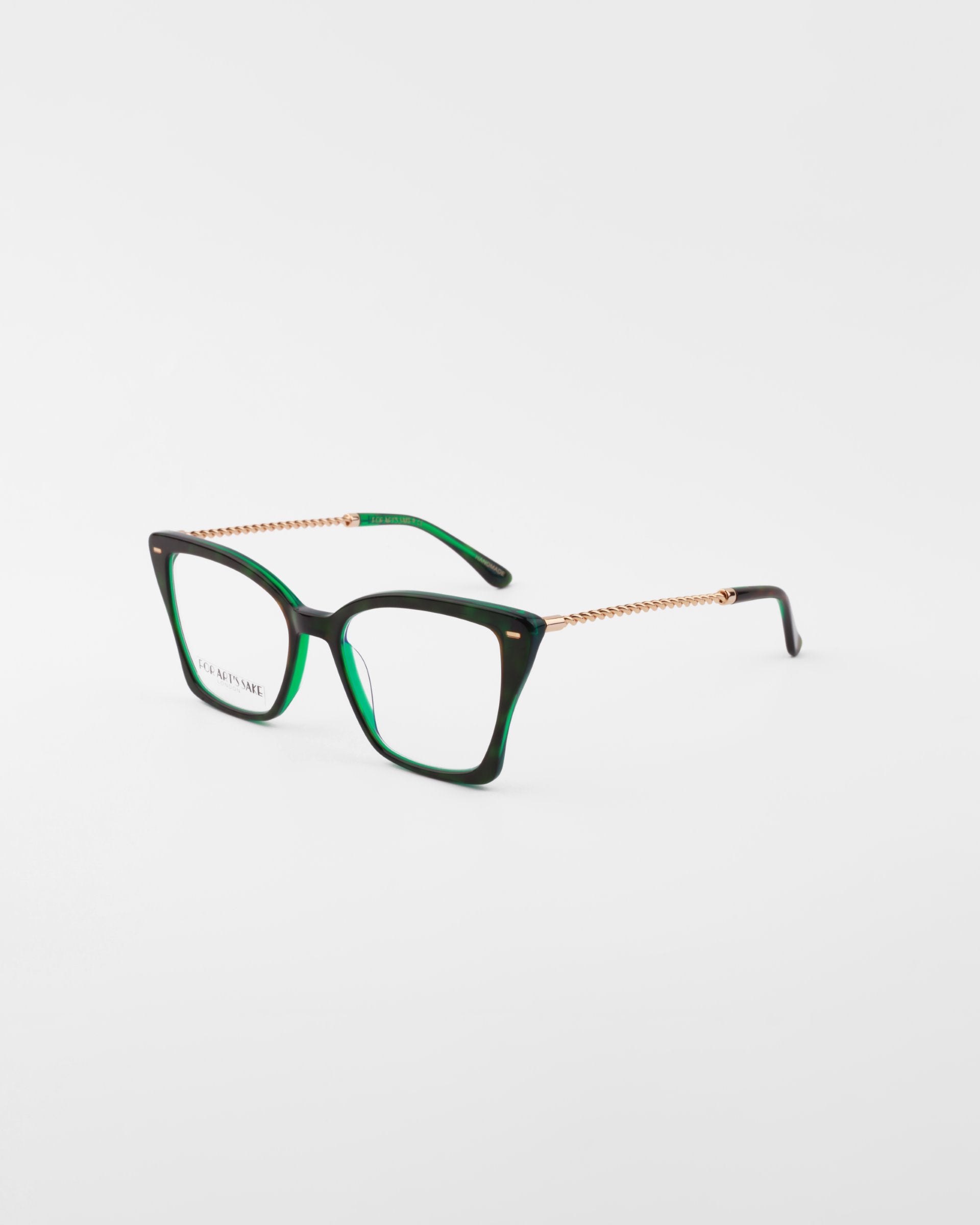 A pair of dark green cat-eye eyeglasses with gold-toned metal temples, featuring clear lenses and a glossy finish. These stylish Dion glasses by For Art&#39;s Sake®, enhanced with blue light filter lenses, are photographed against a plain white background.