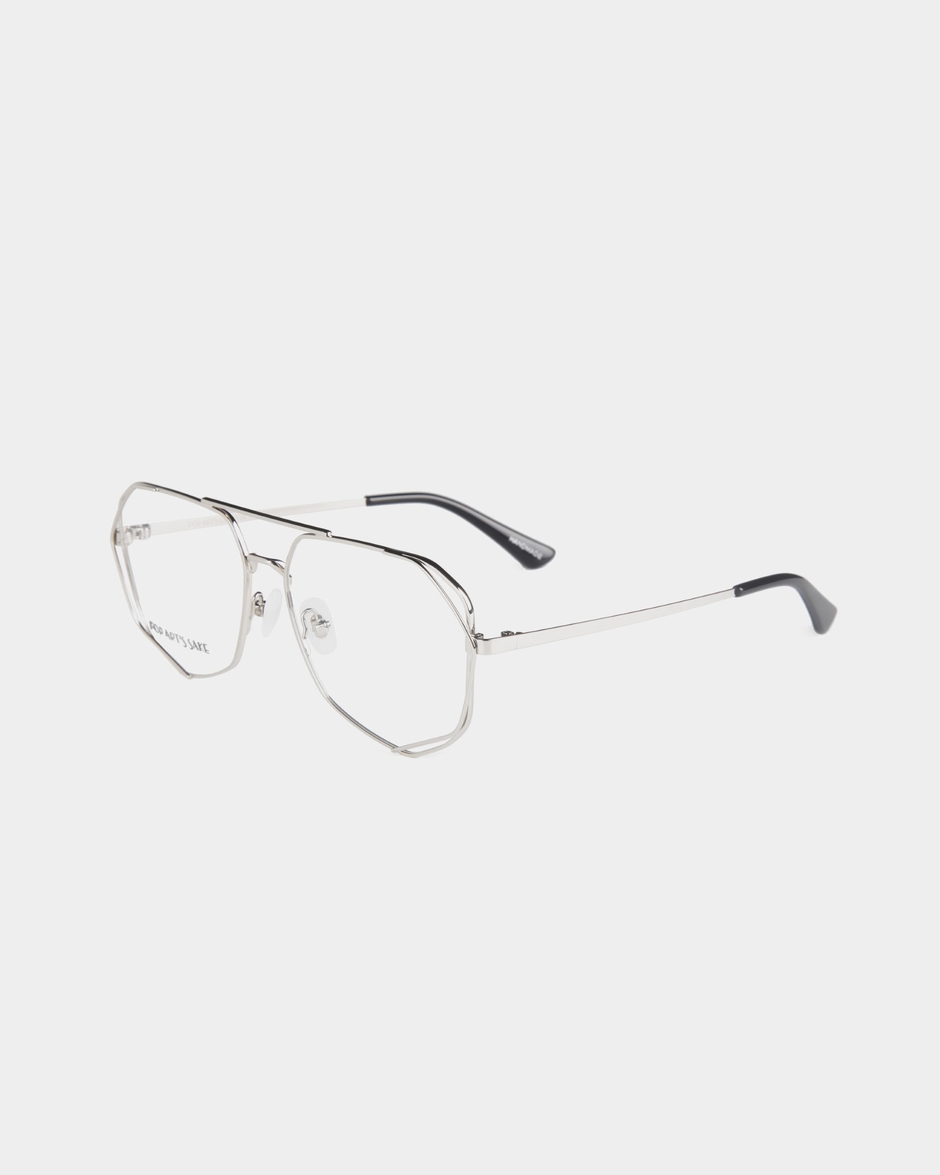 A pair of For Art&#39;s Sake® Genius aviator-style eyeglasses with stainless steel frames, clear lenses, and black temple tips. The design is minimalist and modern. The background is plain white.