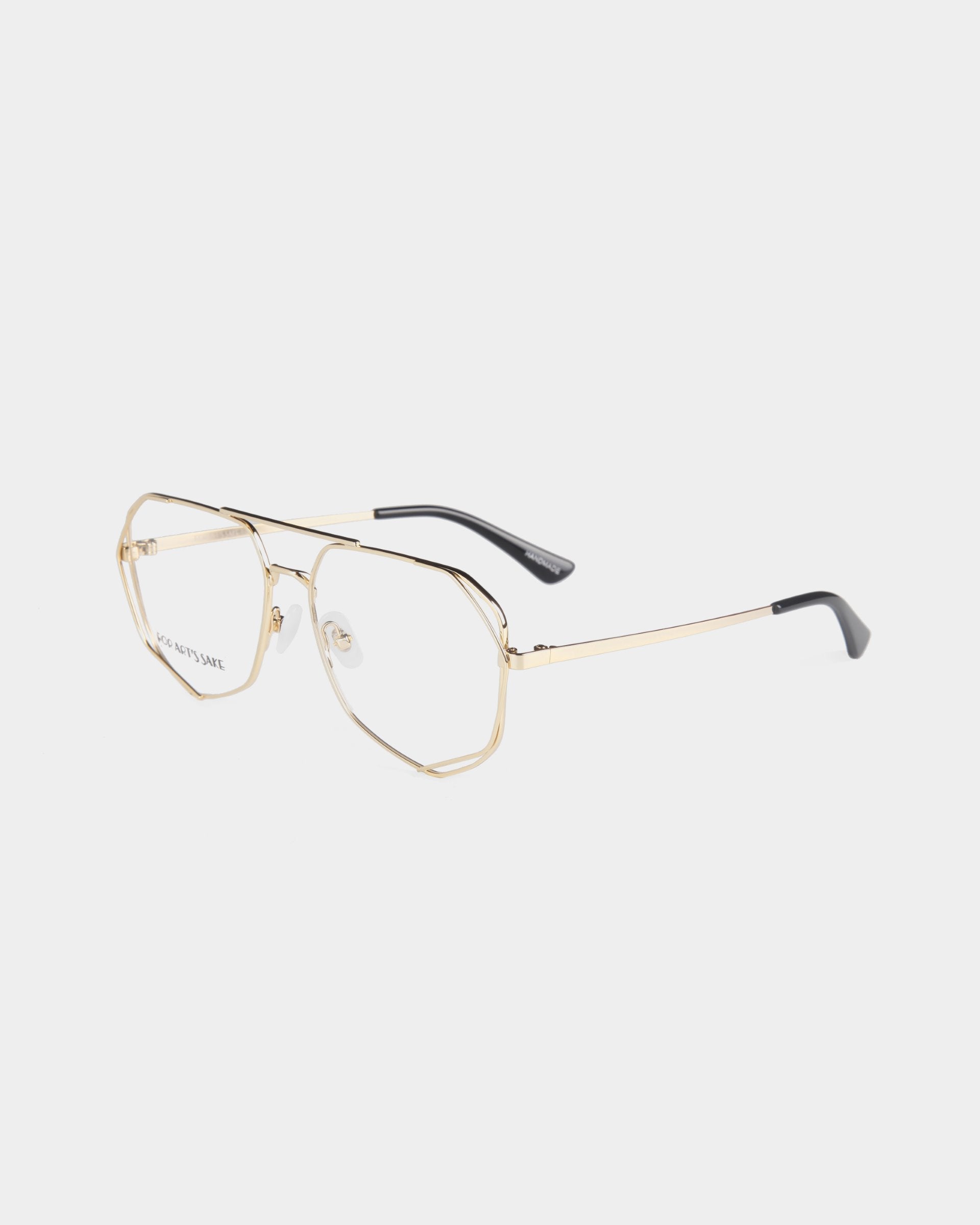 A pair of Genius eyeglasses with a thin stainless steel frame by For Art&#39;s Sake®. The lenses are clear, the nose pads are adjustable, and the temple tips are black. The design is sleek and modern, with an angular shape. Available with a blue light filter or via prescription service, they are displayed against a white background.