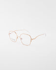 A pair of For Art's Sake® Mimi eyeglasses with thin, 18-karat gold-plated metal frames and slightly geometric lenses. The glasses are positioned at an angle on a white background, showcasing the streamlined arms and clear lenses.