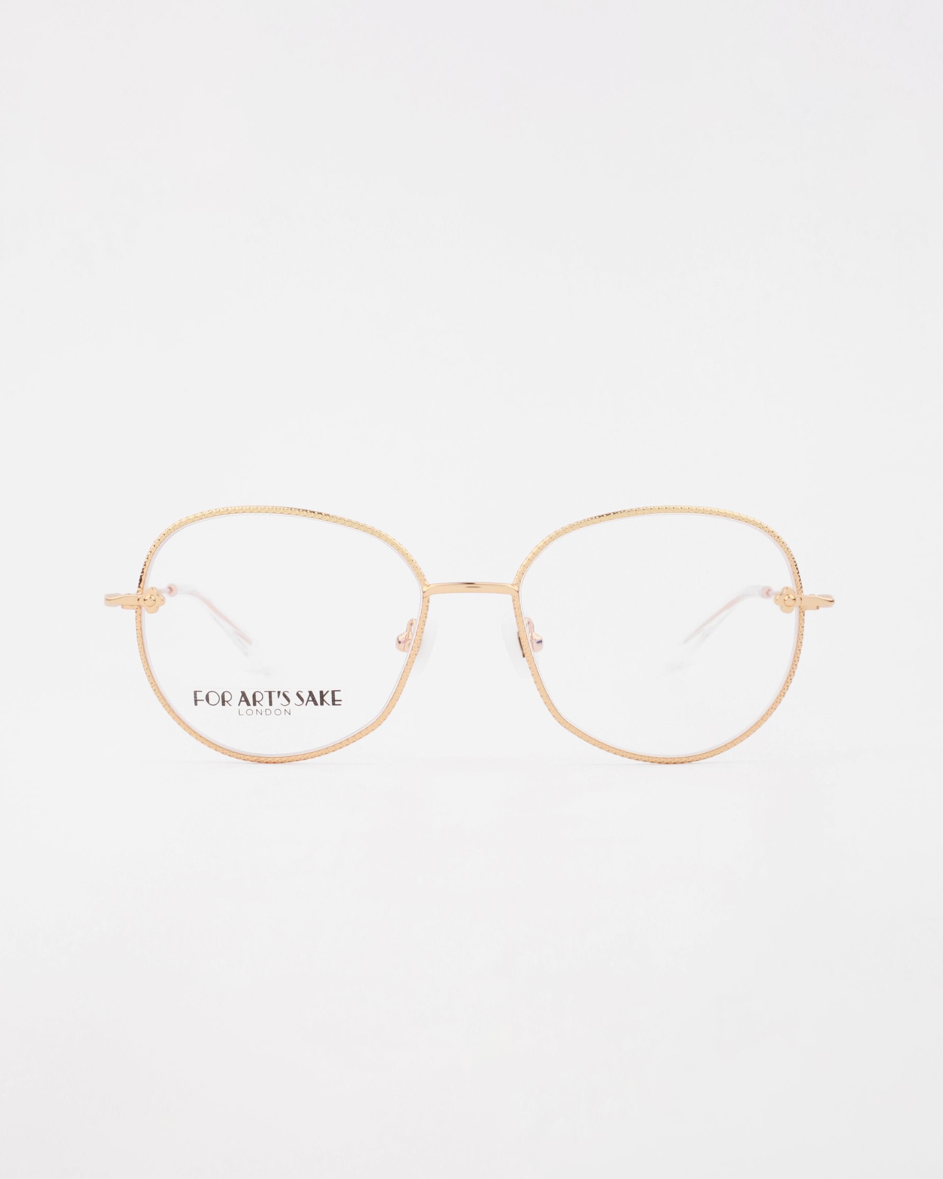 A pair of elegant handmade Jasmine eyeglasses with thin, gold-plated stainless steel frames against a white background. The frames have a square design with slightly rounded edges. The left lens has the brand name &quot;For Art&#39;s Sake®&quot; printed in black text.