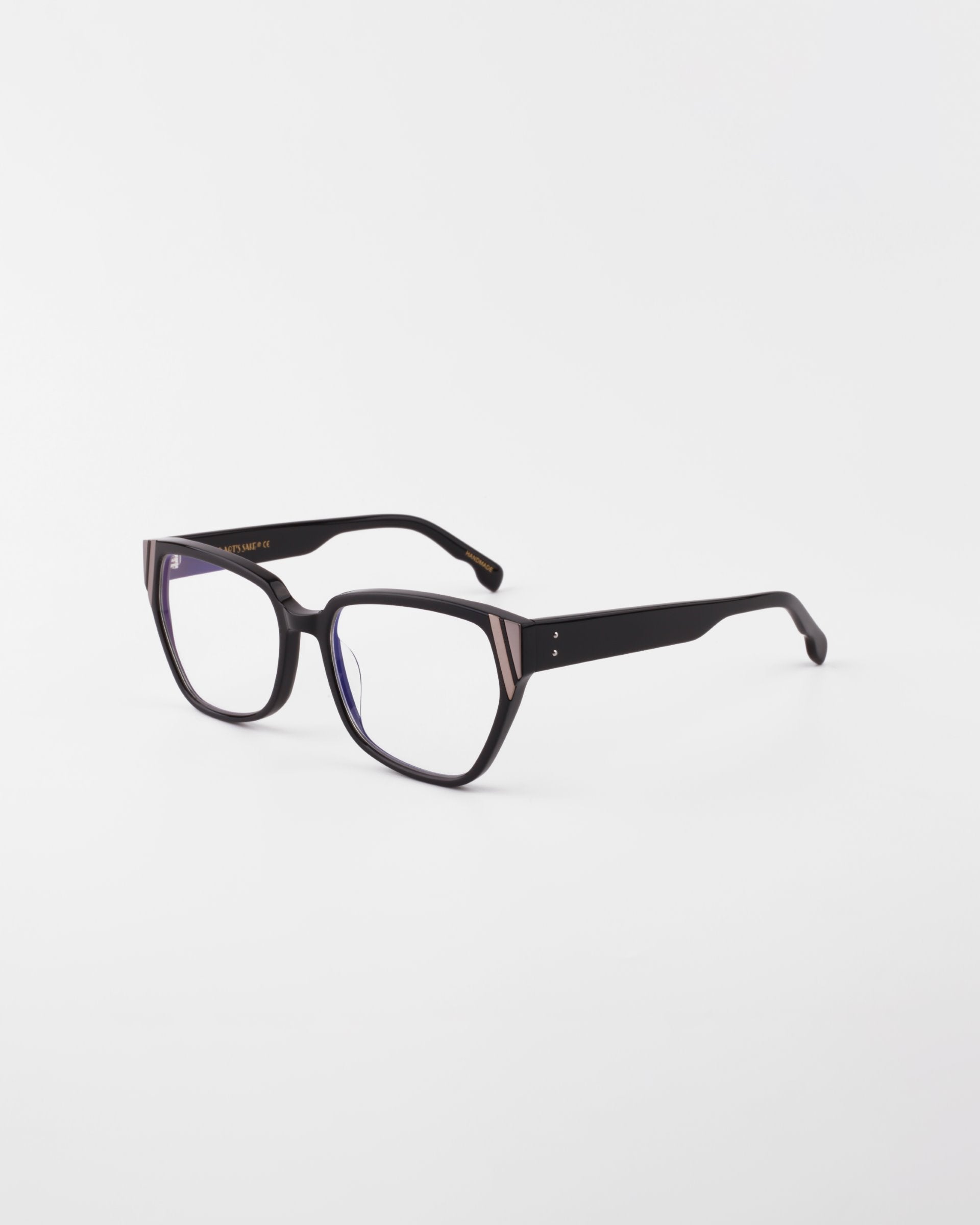 Below Zero by For Art's Sake®: Black rectangular eyeglasses feature a modern flair with a subtle gold accent on the frame, set against a plain white background.