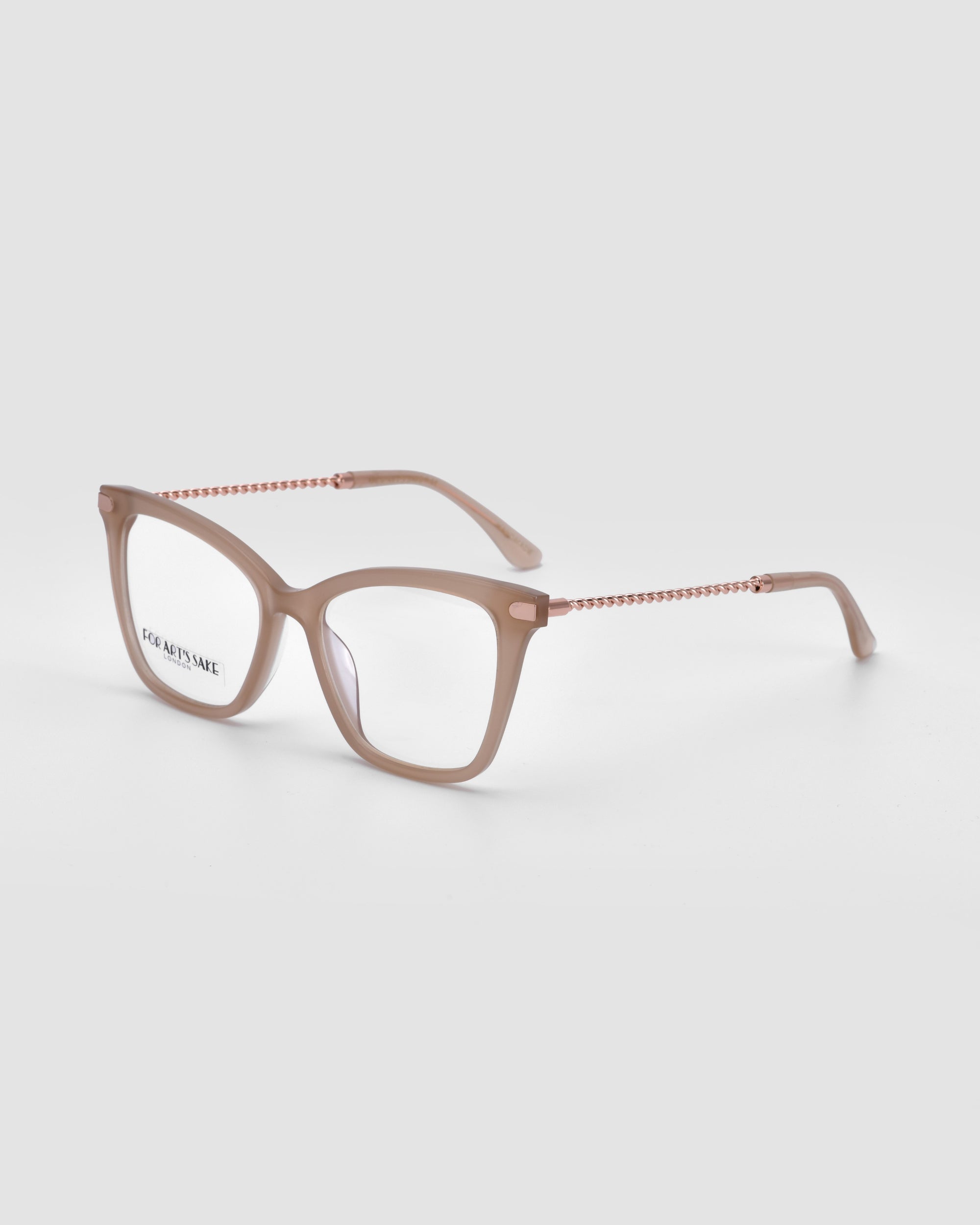 The Paris Two eyeglasses by For Art's Sake® feature translucent beige square frames with thin arms adorned with a chain-like pattern. Set against a plain light grey background, these stylish frames include a blue light filter and have text printed on the left lens.