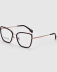 A pair of For Art's Sake® Lace eyeglasses featuring thin, metallic rose gold frames with black rims around the prescription lenses. The temples showcase a subtle braided design and conclude with black earpieces. The glasses are positioned with the lenses facing forward against a plain white background.