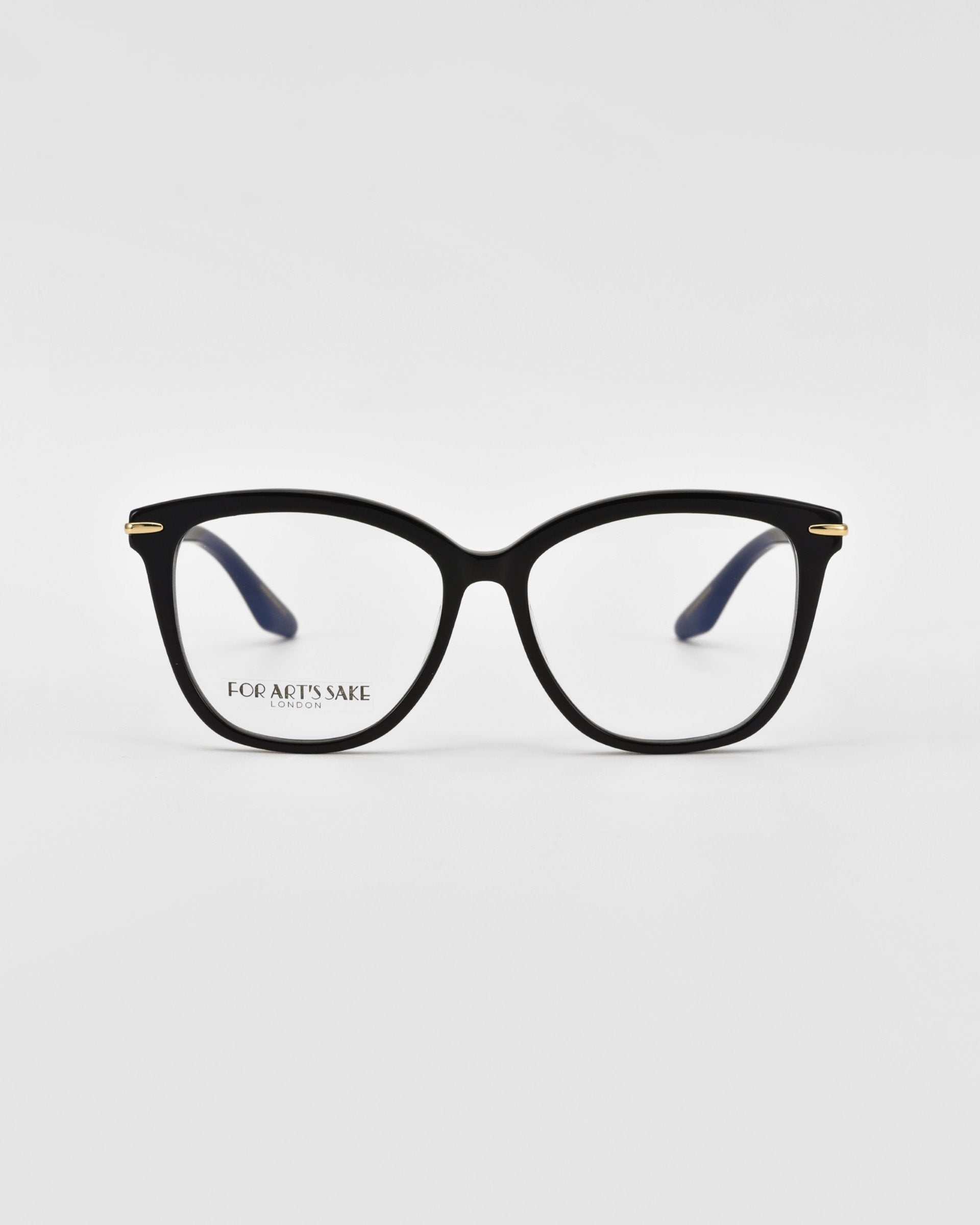 A pair of black rectangular Cadenza optical glasses with a slight cat-eye shape, featuring gold accents on the temple arms. The glasses are displayed against a plain white background. The brand name "For Art's Sake®" is visible on the inner side of the right lens.