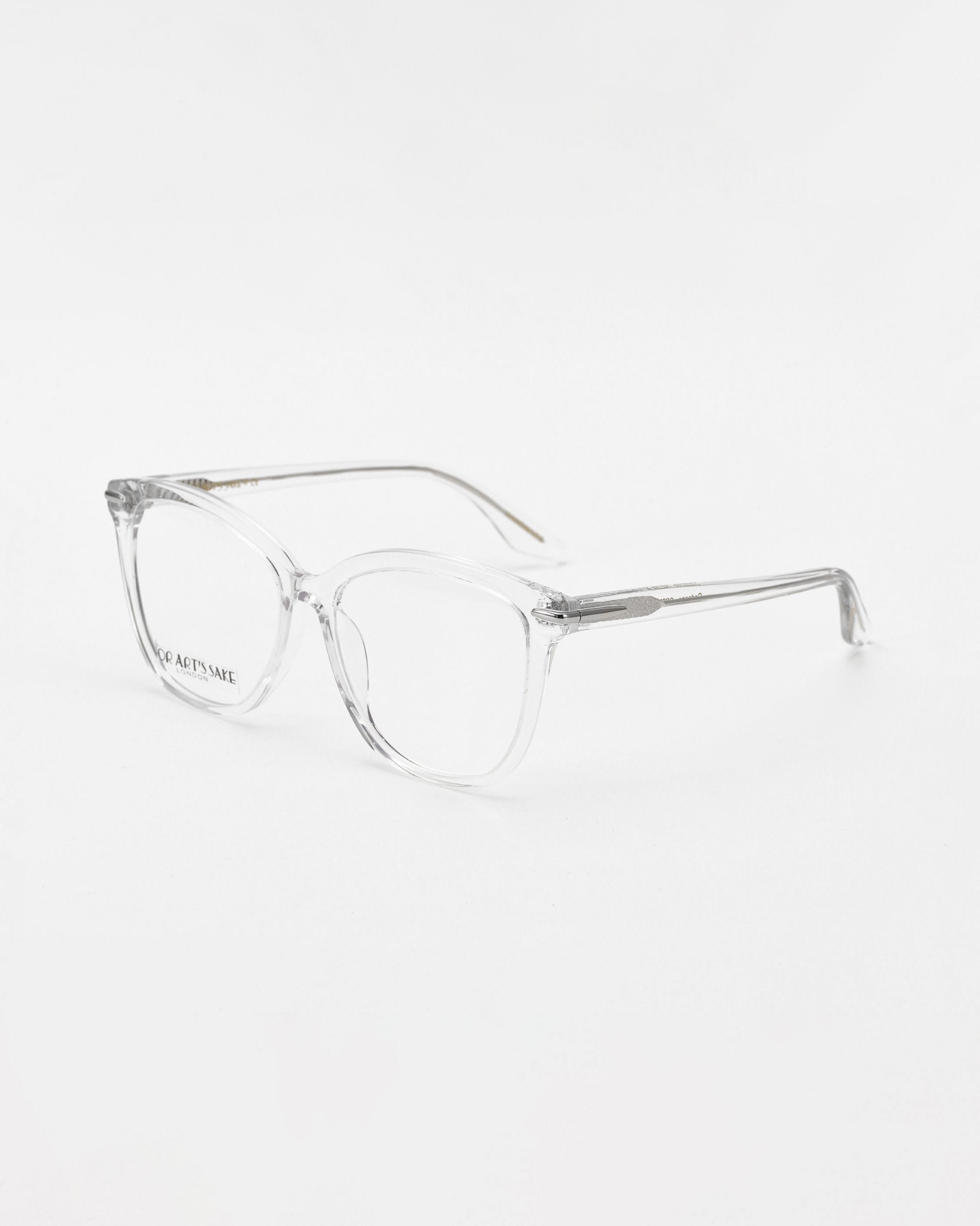 Clear, rectangular For Art's Sake® Cadenza optical glasses with transparent frames on a white background. The glasses have a simple and minimalist design, with sleek, thin, and unobtrusive arms.