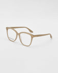 A pair of beige prescription eyeglasses with rectangular frames, crafted by For Art's Sake® Cadenza, and the text "FOR ART'S SAKE" visible on the inside of the right lens, set against a plain white background.