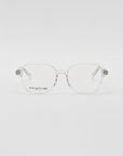 A pair of For Art's Sake® Charm transparent framed optical glasses in a cat-eye shape on a white background, with a visible brand name etched on one lens.