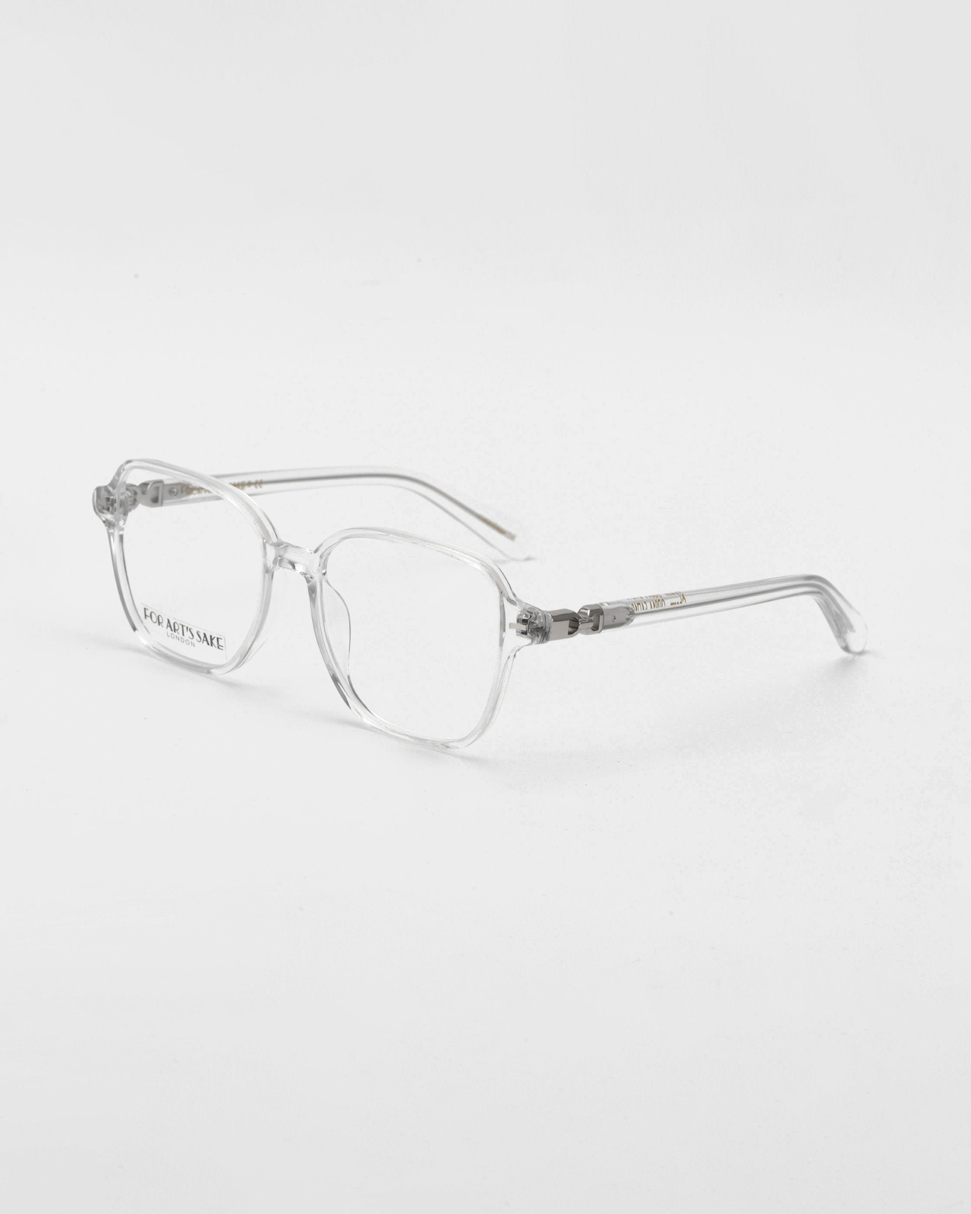 A pair of For Art&#39;s Sake® Charm transparent framed optical glasses in a cat-eye shape against a white background.