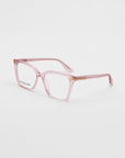 A pair of pink, rectangular eyeglasses with glossy acetate frames and clear lenses. The glasses have metal accents on the hinges and arms. The words "For Art's Sake®" are visible on one of the lenses. These Azure optical glasses are placed on a white background.