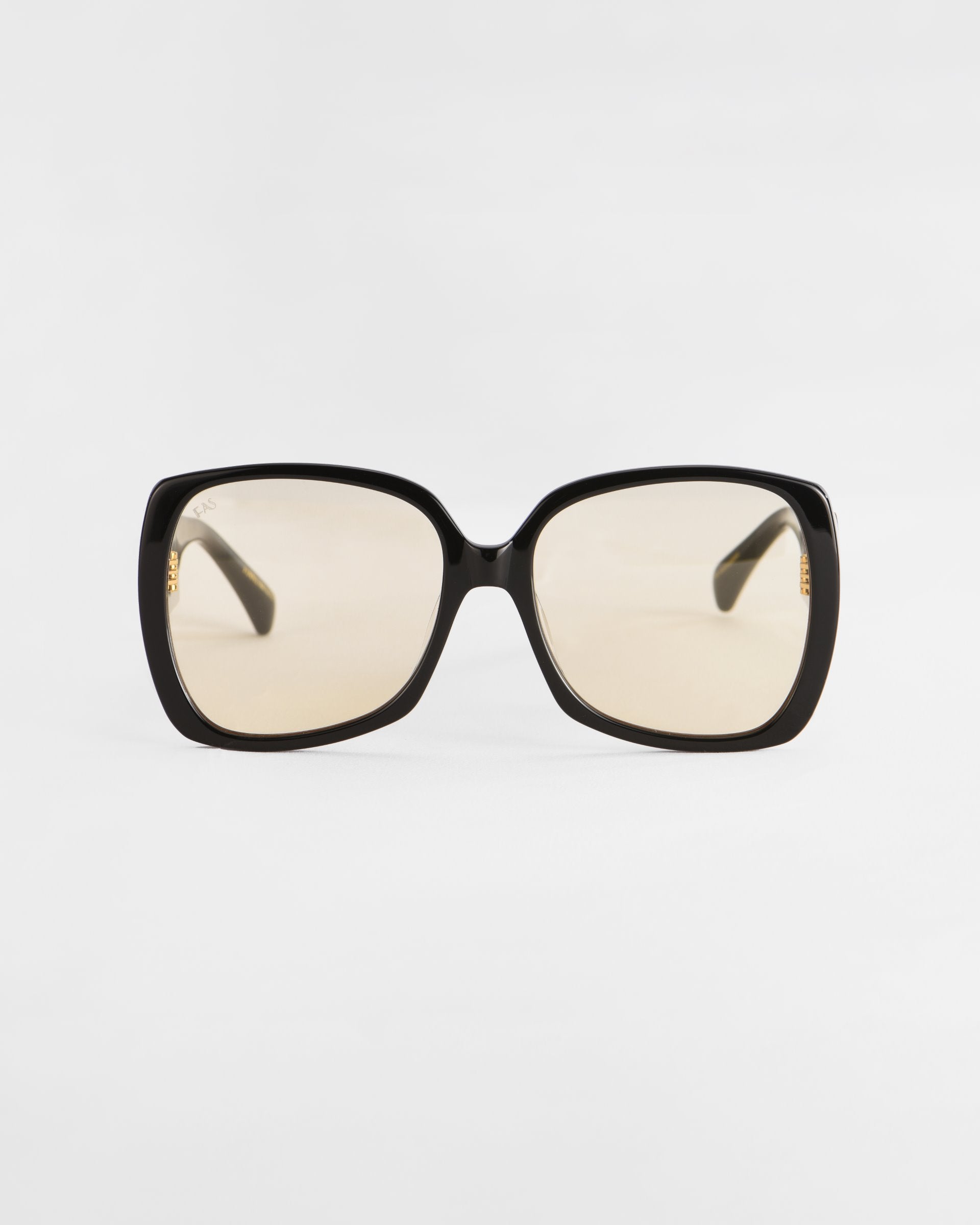 A pair of oversized, square-shaped Odyssey sunglasses with black frames and lightweight nylon lenses from For Art&#39;s Sake® is centered against a white background. The design is simple and sleek, emphasizing the eyewear&#39;s fashion-forward and contemporary style.
