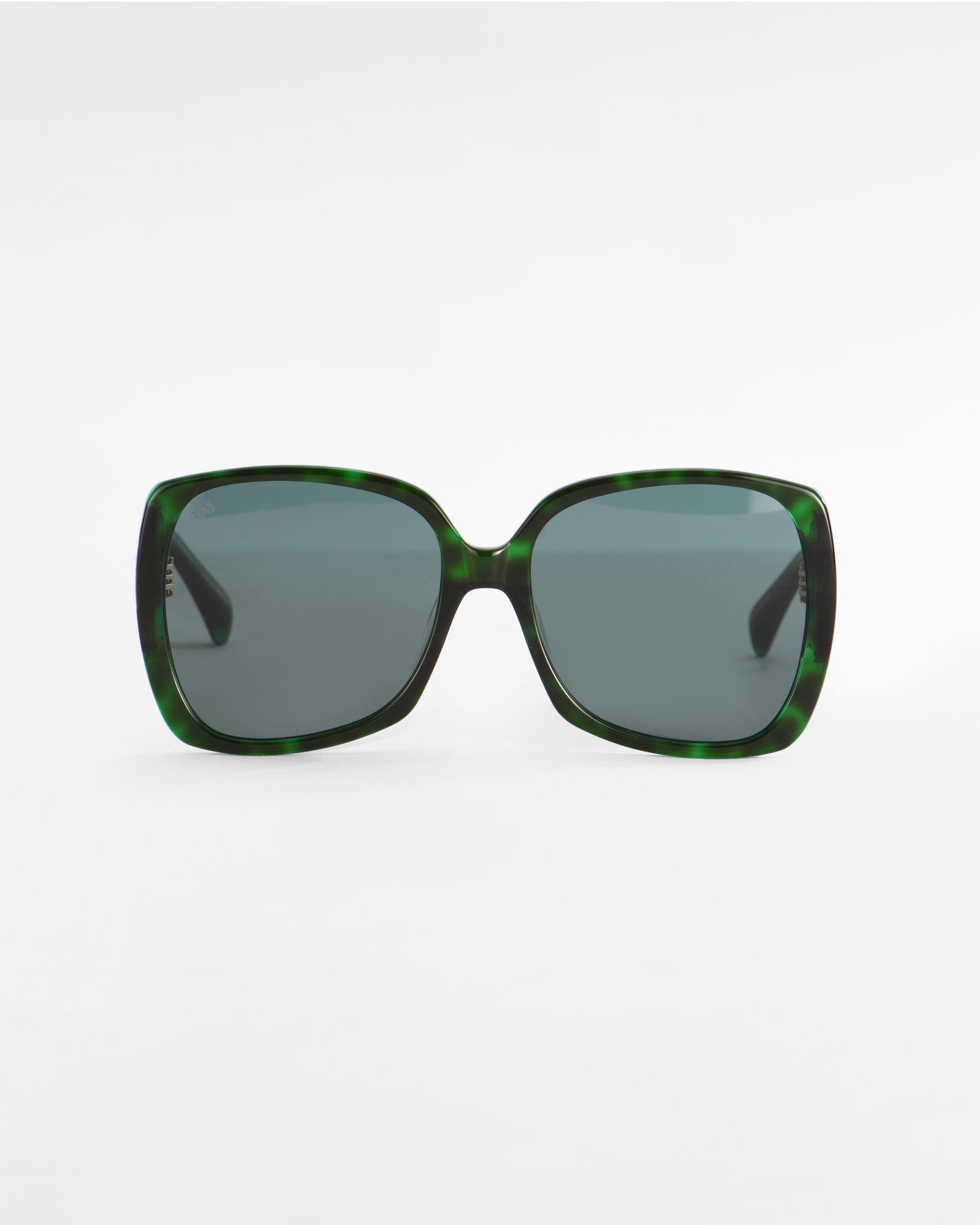 A pair of green, square-shaped Odyssey sunglasses by For Art&#39;s Sake® with dark tinted, lightweight nylon lenses against a plain white background. The frame features plant-based acetate with a subtle marbled pattern, adding a textured look.