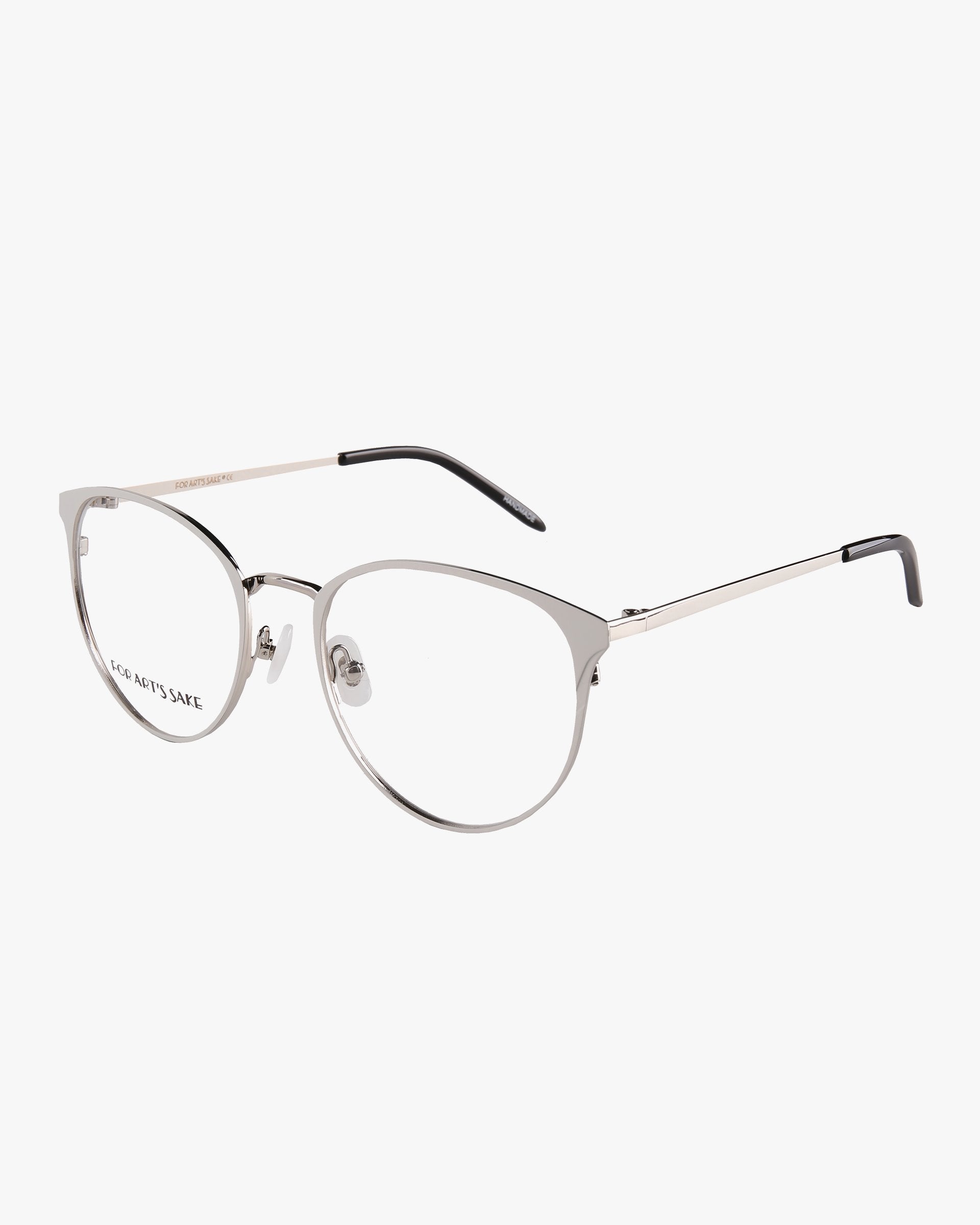 A pair of sleek, modern For Art's Sake® Olivia Grey eyeglasses with thin, metallic silver frames and clear lenses. The temples are straight with black ends, adding a contrasting detail to the design. Featuring a slight cat-eye shape with a minimalist aesthetic, these opticals on sale include an optional prescription service for added convenience.